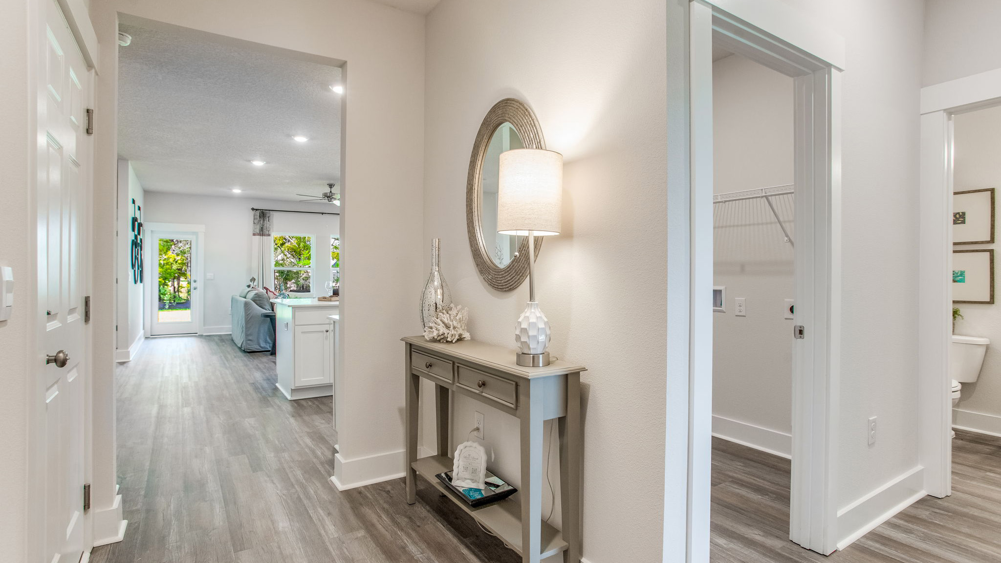 Off the foyer there is a hall that leads to a guest bedroom, laundry room and full bathroom