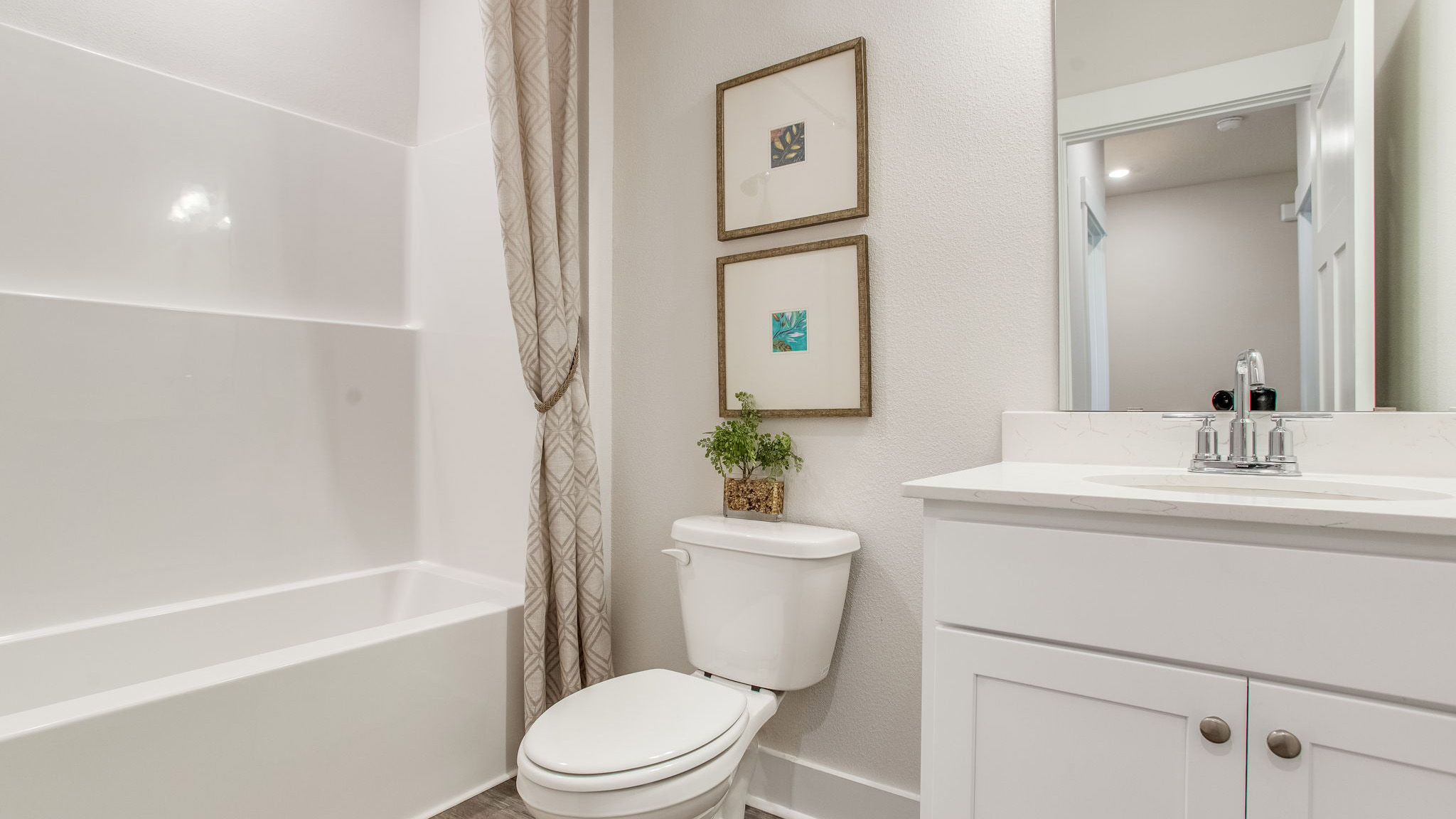 The full bathroom has a shower tub combination