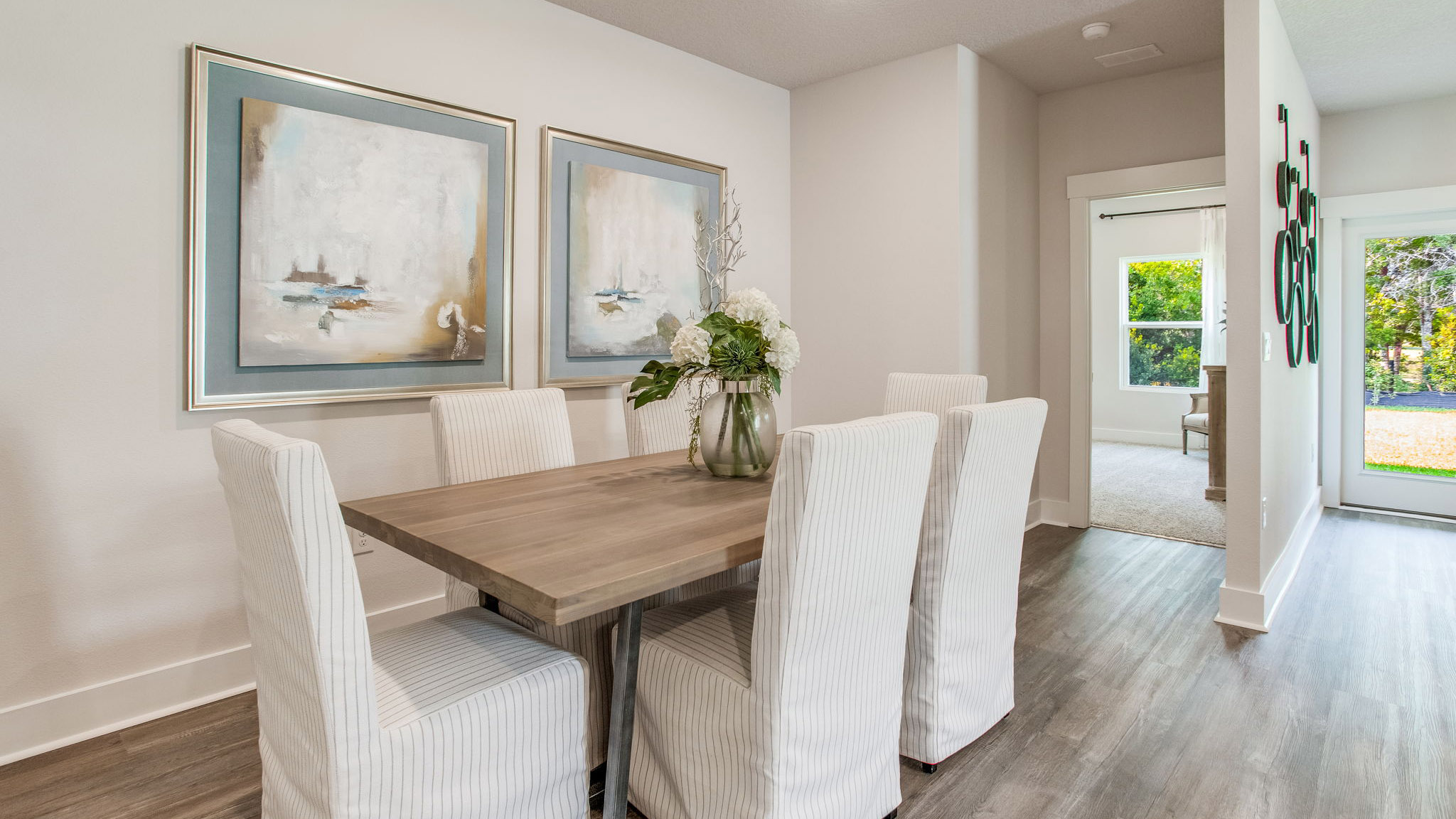 The dining area is shown with a table and seating for six
