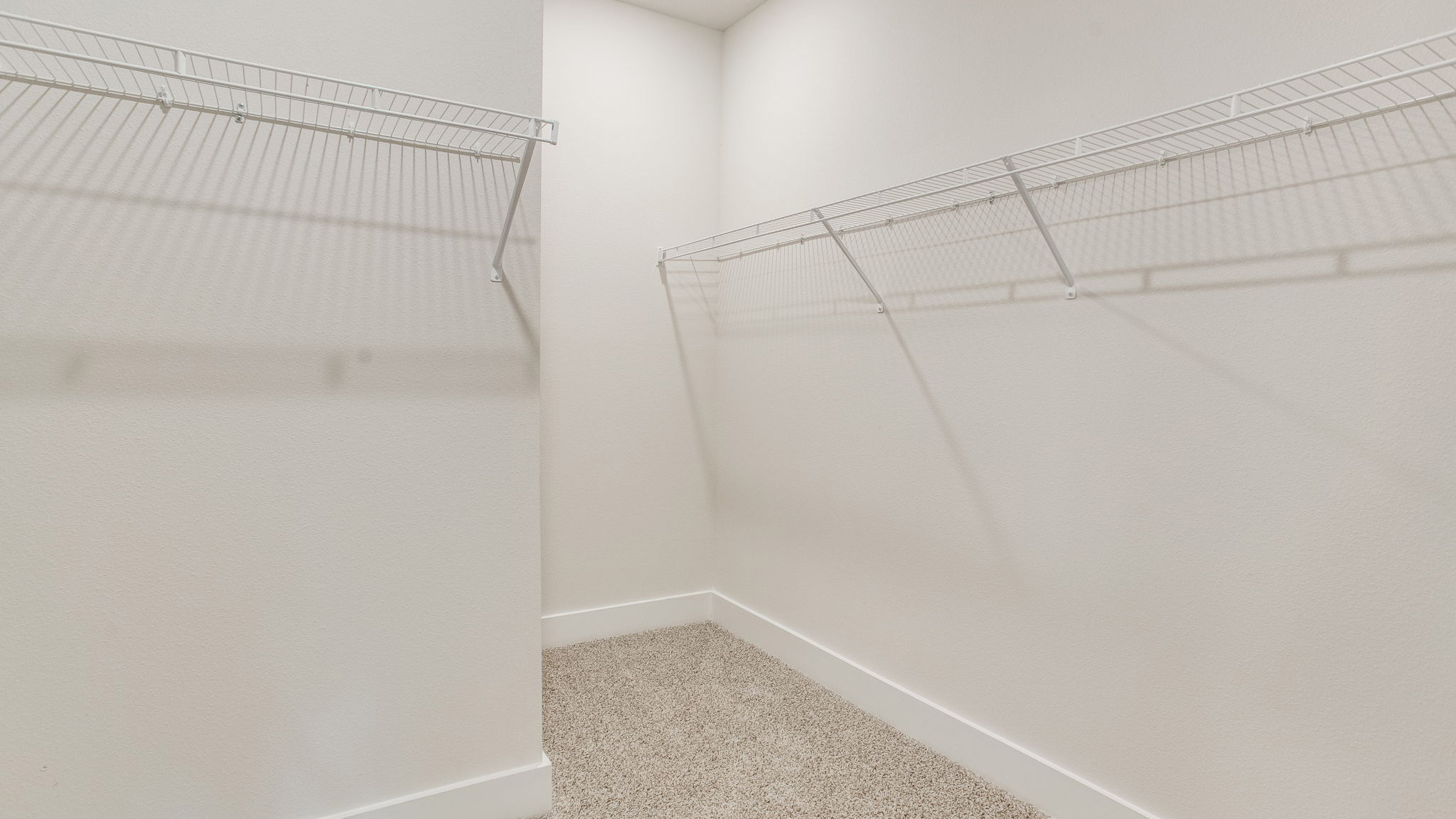 There is a spacious walk-in closet in the primary bathroom with ventilated shelving