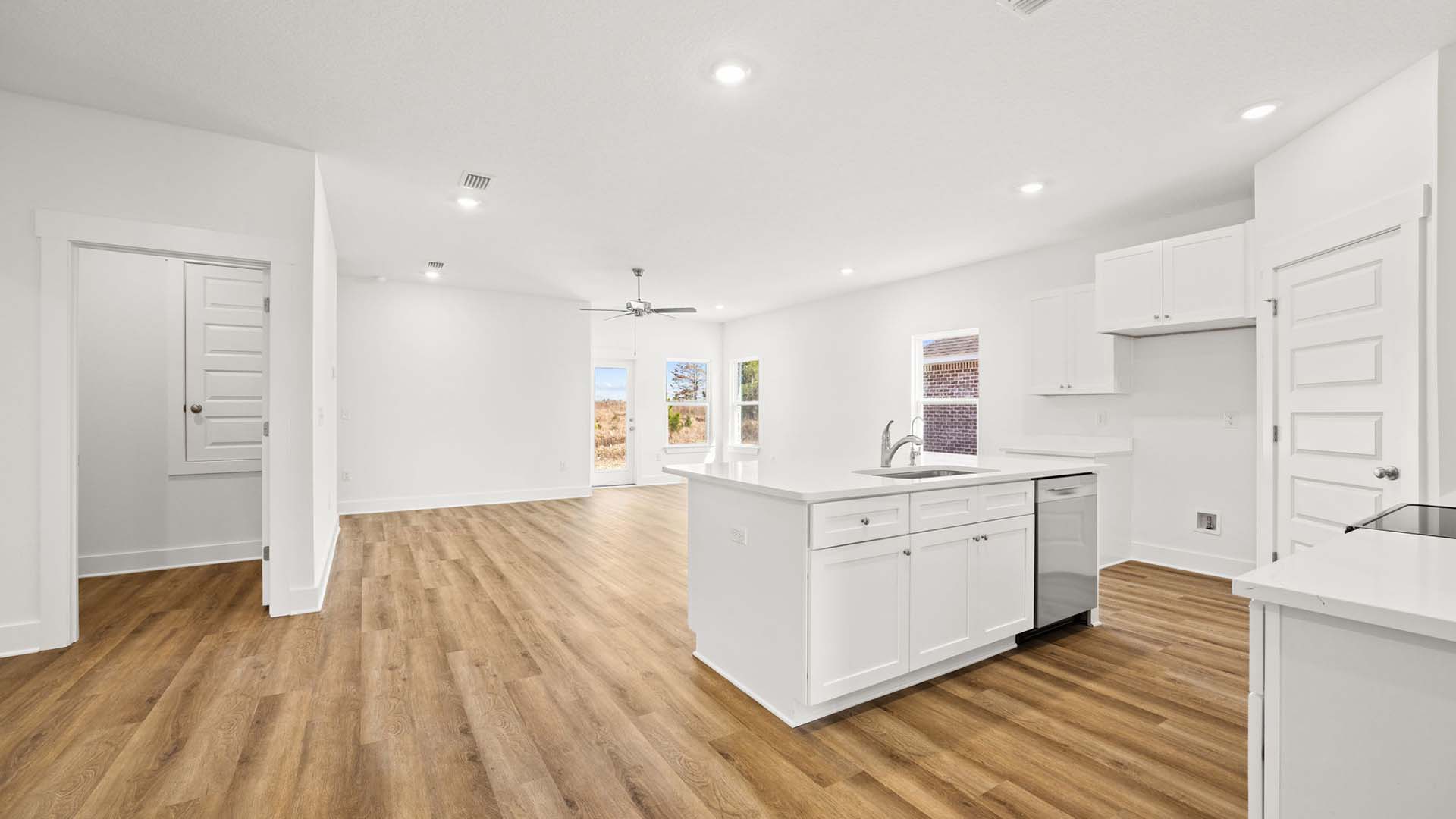 The open concept design includes a dining area, living room and kitchen with center island