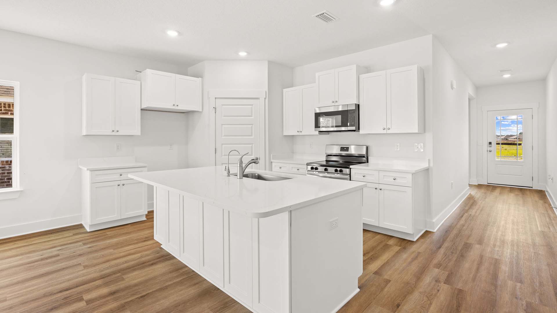 The kitchen has a center island with lower cabinetry and space for seating