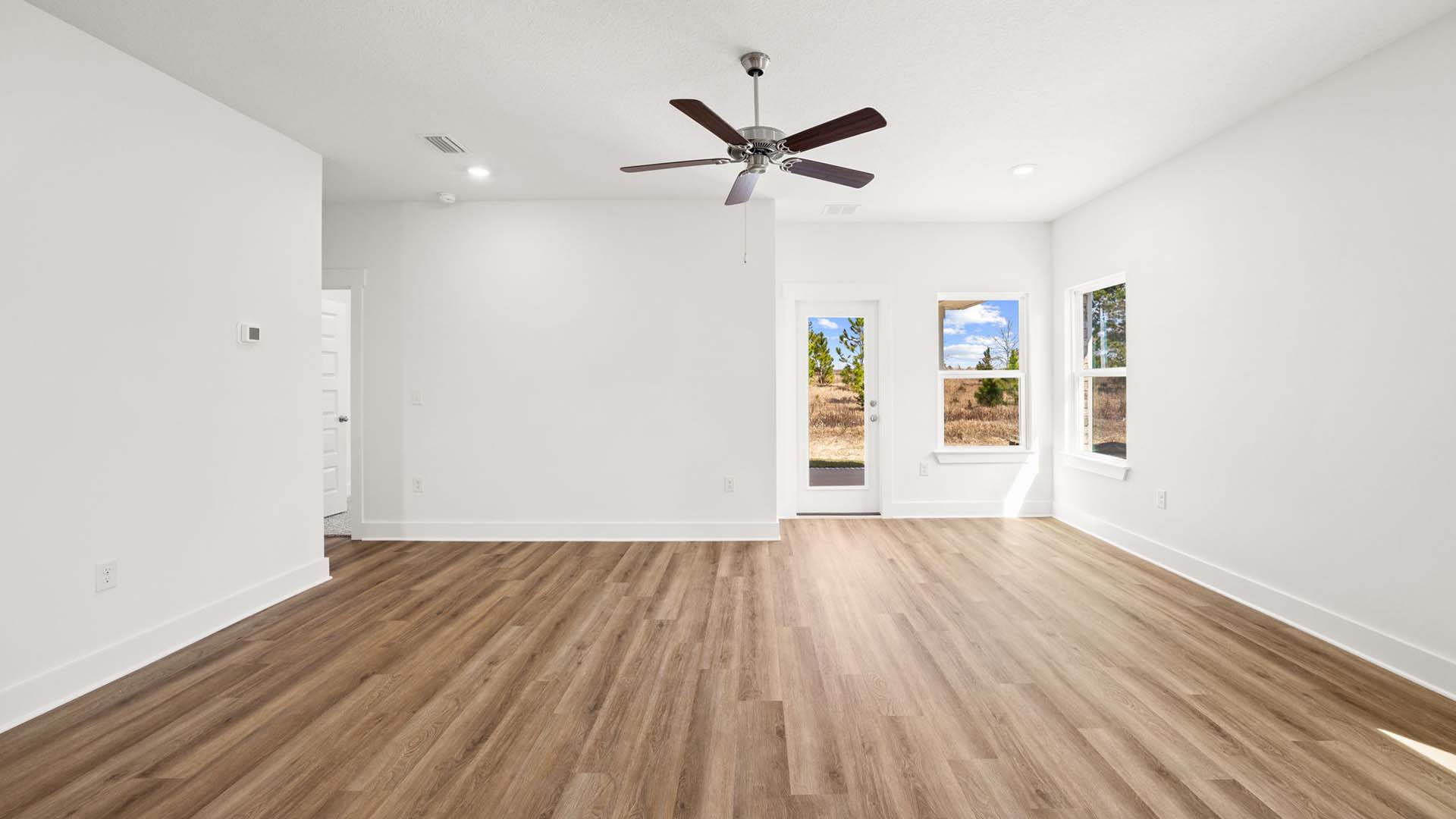 The living room has a ceiling fan