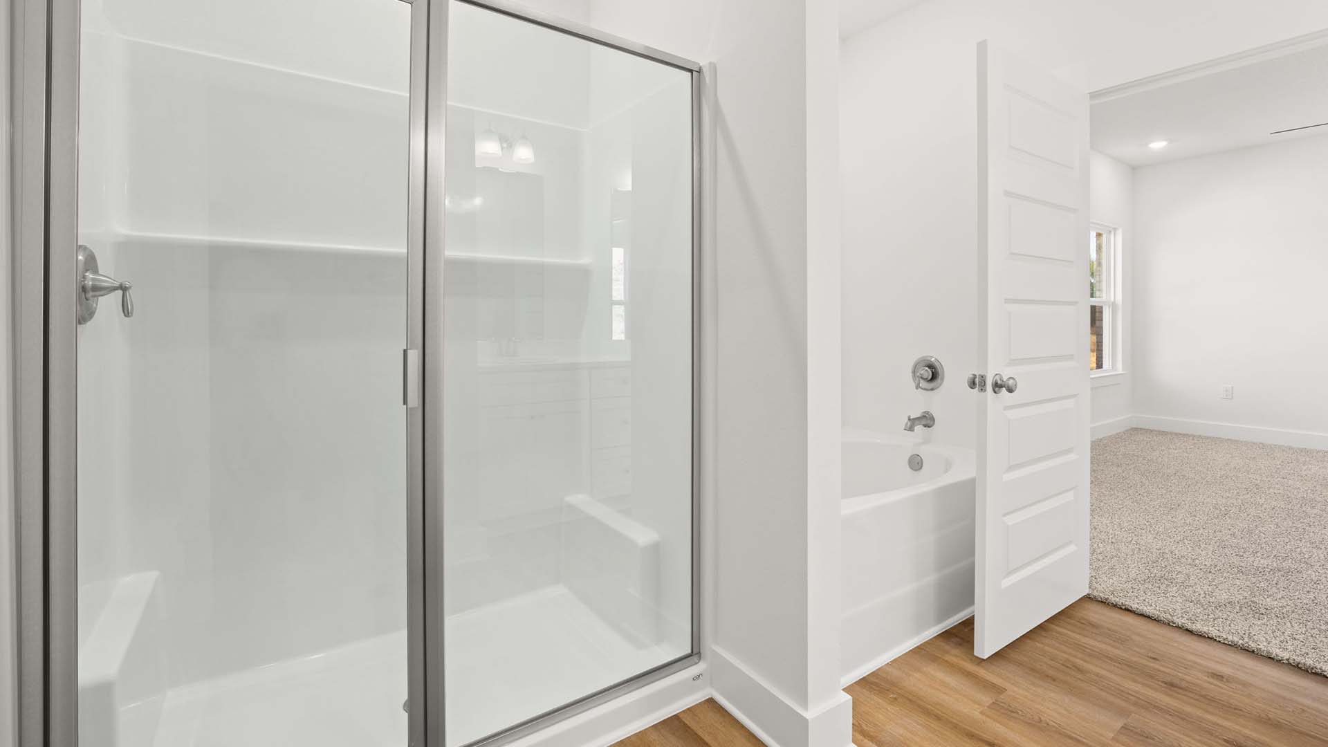 The primary bathroom has a separate shower and soak tub