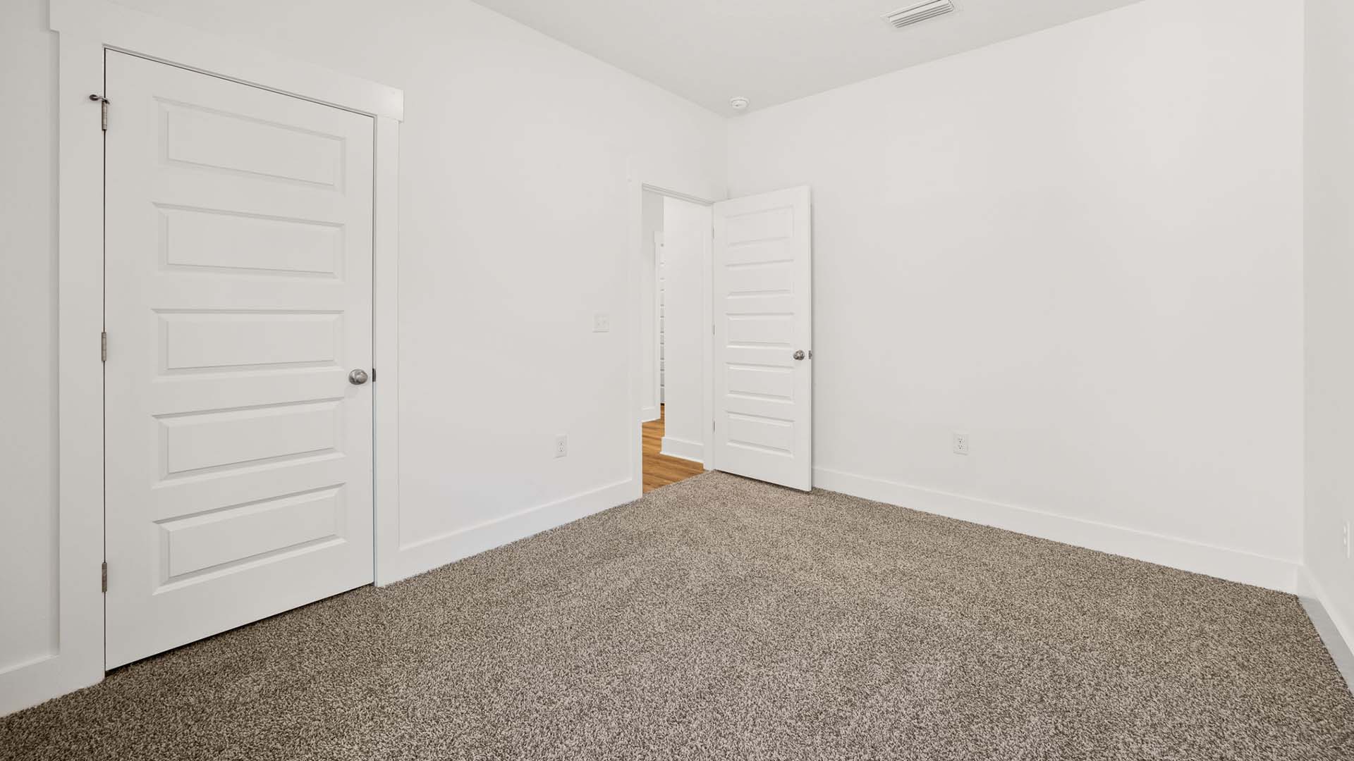 Two guest bedrooms are off the front entry hall