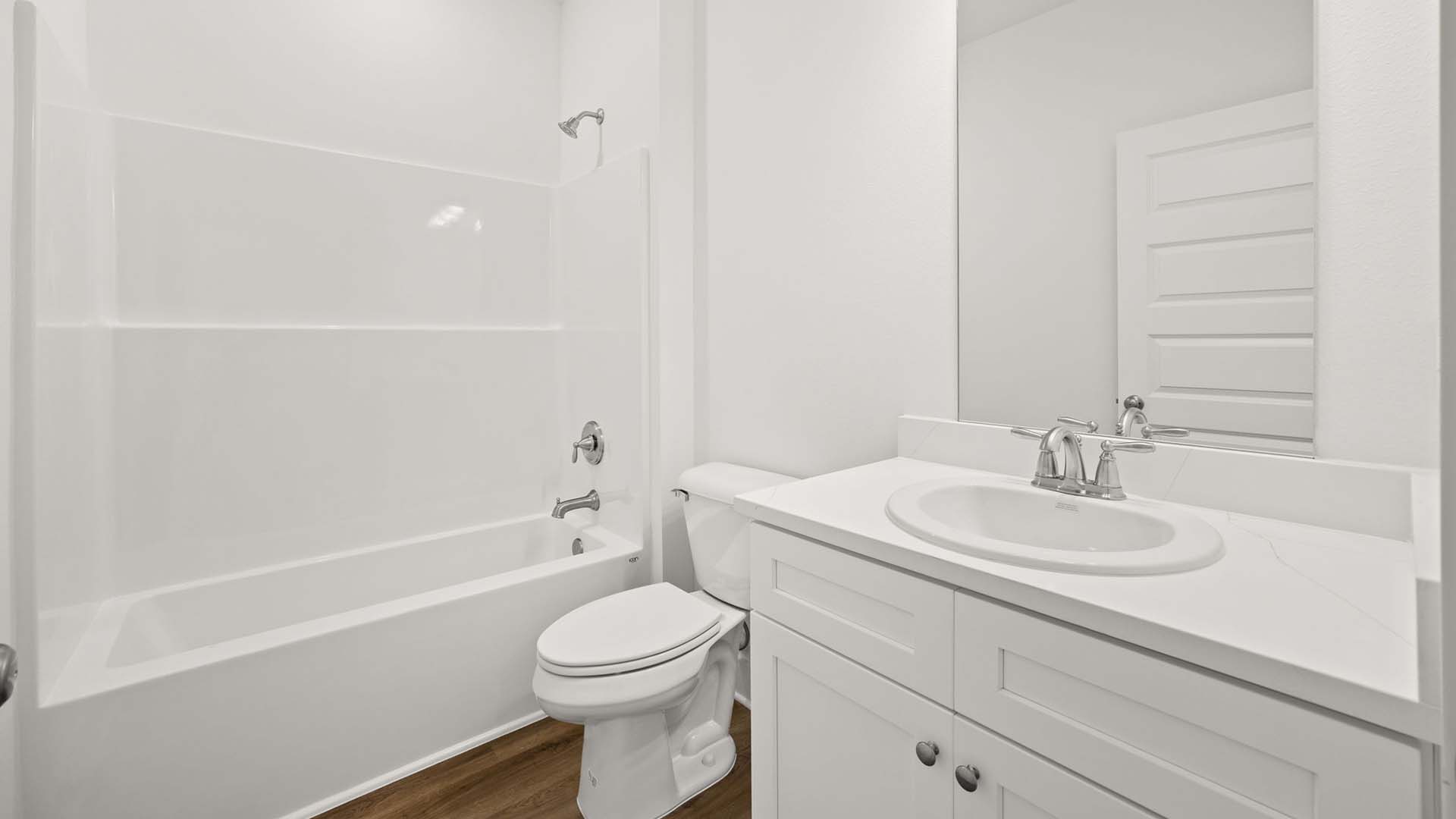 Two guest bedrooms have a shared bathroom with shower tub combo