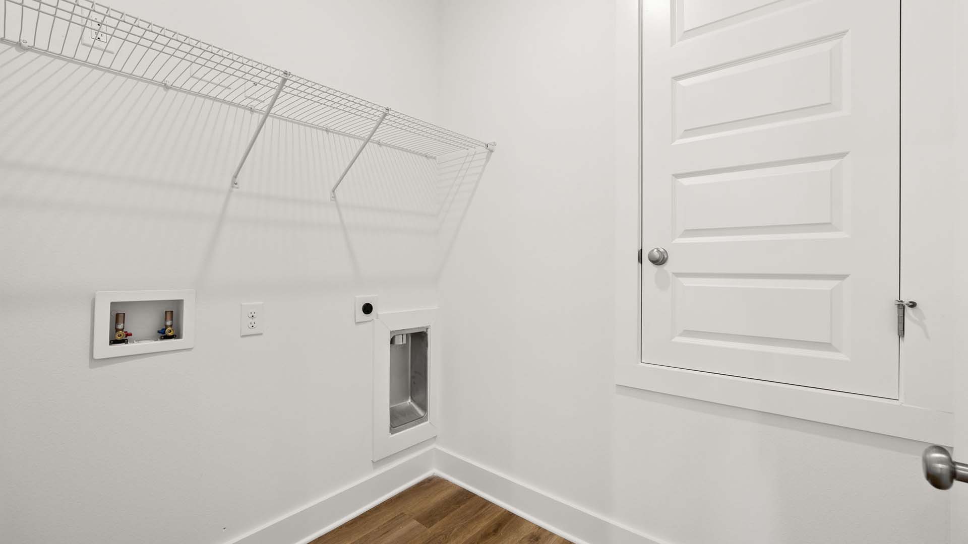 The laundry room has space for a full size washer and dryer