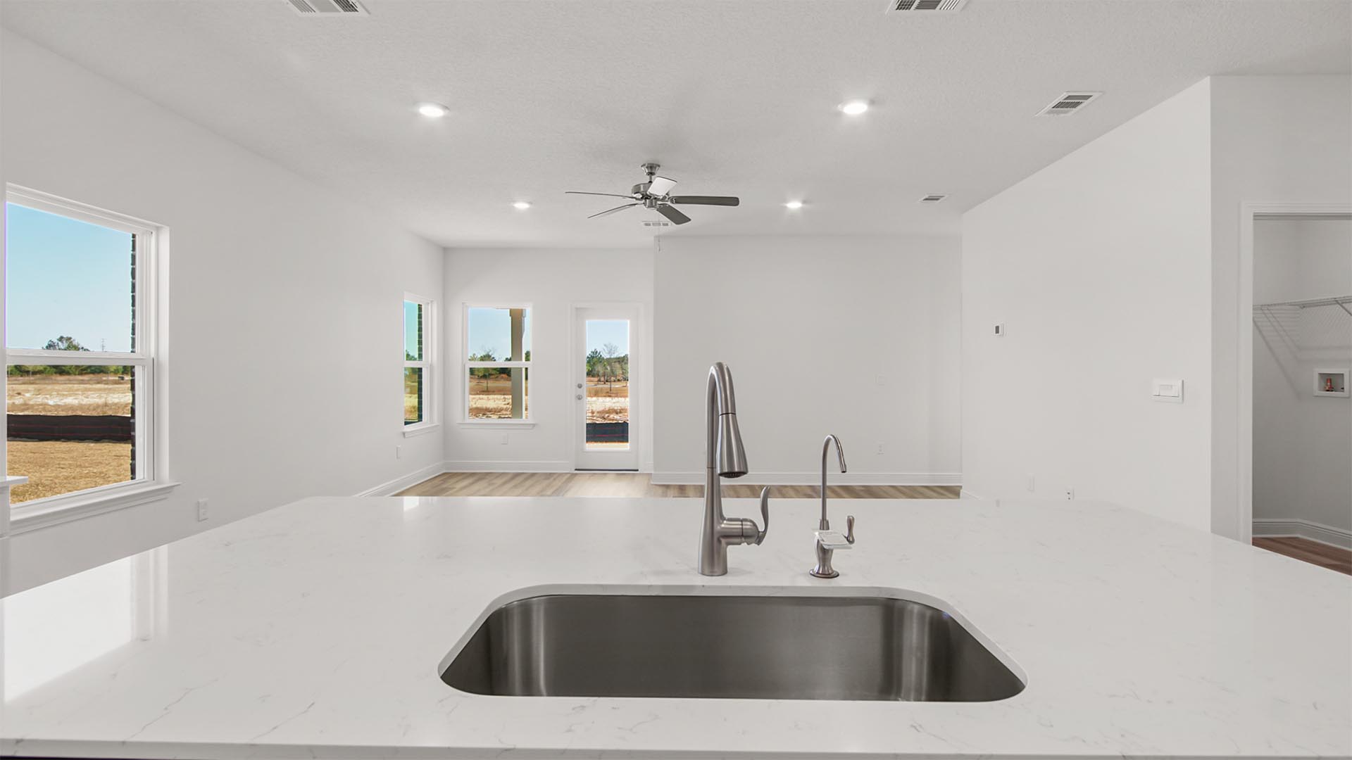 Beautiful quartz countertops and island with sink including a faucet for water filtration hookup