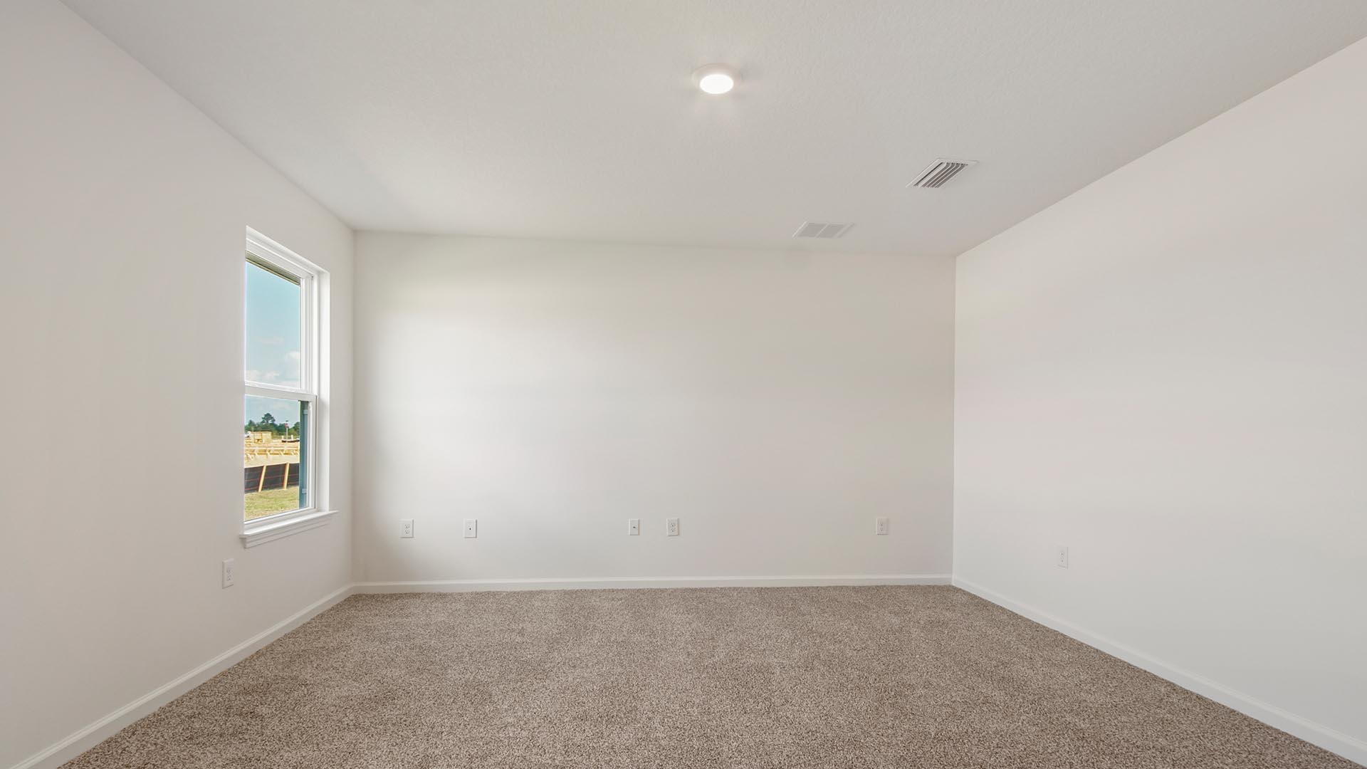 The primary bedroom is spacious and has carpet