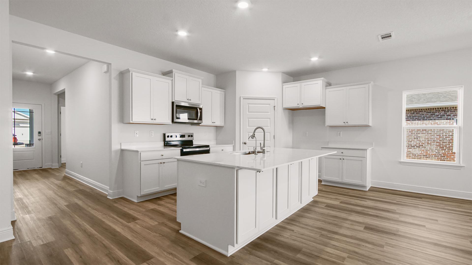 The kitchen has beautiful white cabinetry