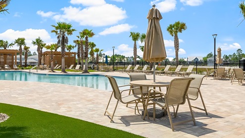 The pool has plenty of seating, shaded area and lounge chairs