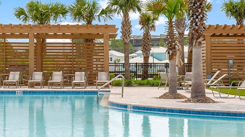 The pool is a resort style with outdoor seating that is a great place to enjoy a book