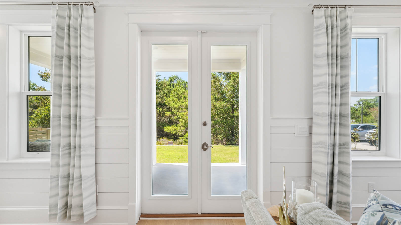 Double doors leading to the back patio have glass panes allowing for natural light