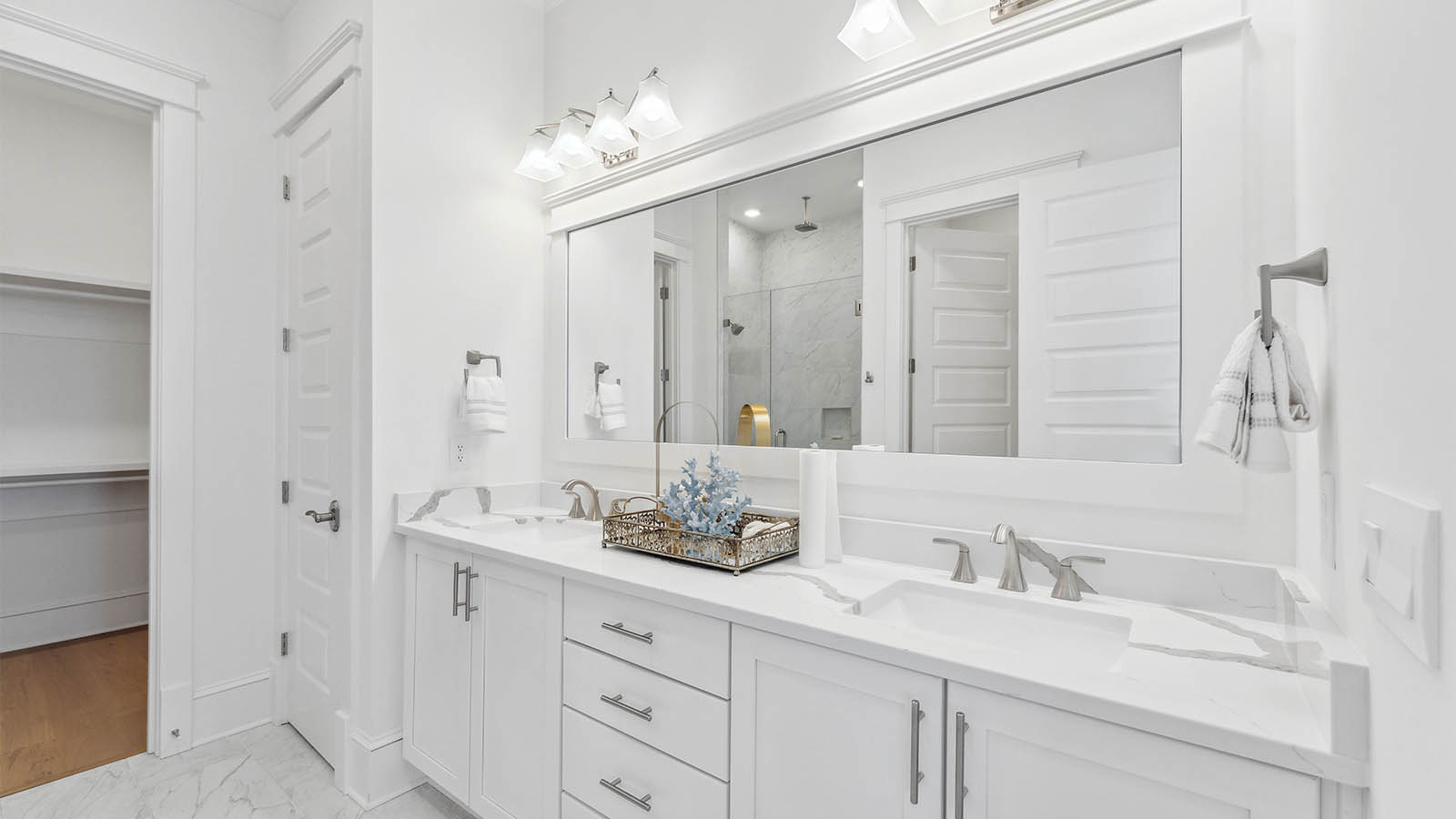 The third level primary bedroom has a private bath with elegant features