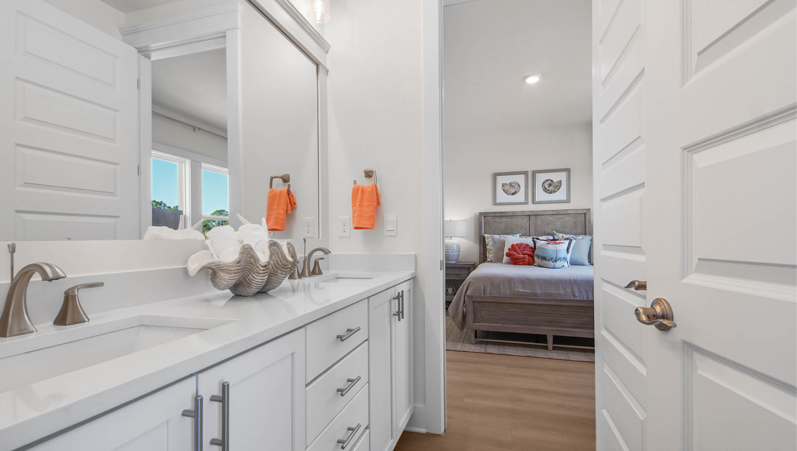 Shared bathroom with quartz countertop and dual sink vanity with lower cabinetry