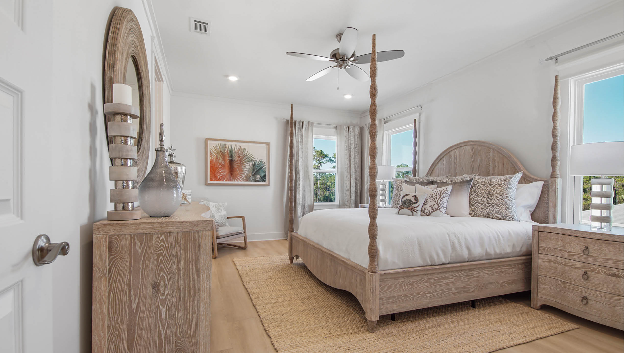 Primary bedroom with ceiling fan and wood floor