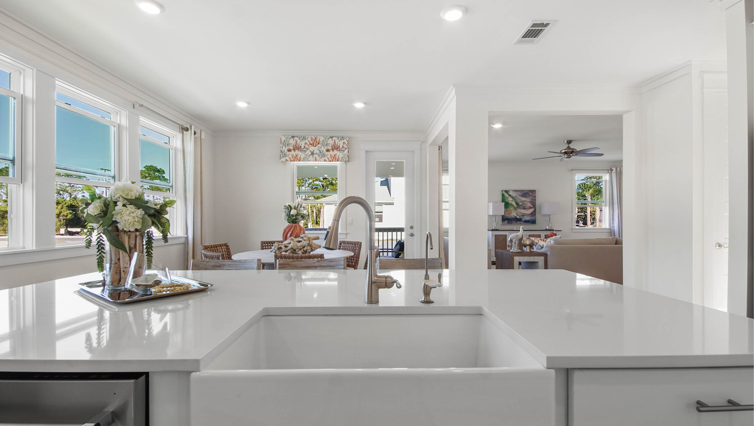 Kitchen overlooking the dining area with quartz countertops and farm sink