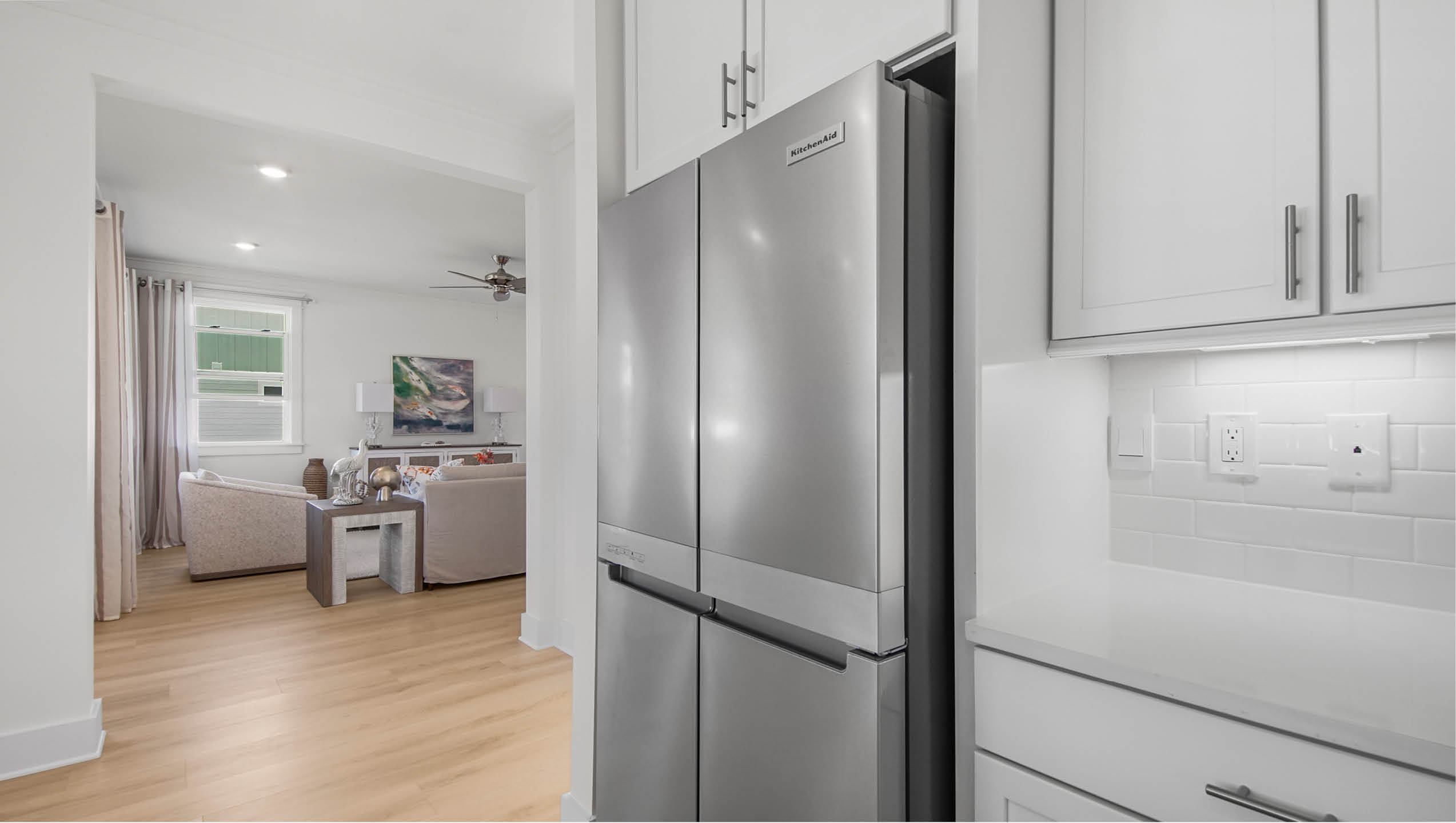 Premium appliances in the kitchen including a refrigerator, wall mount oven, gas cooktop and dishwasher