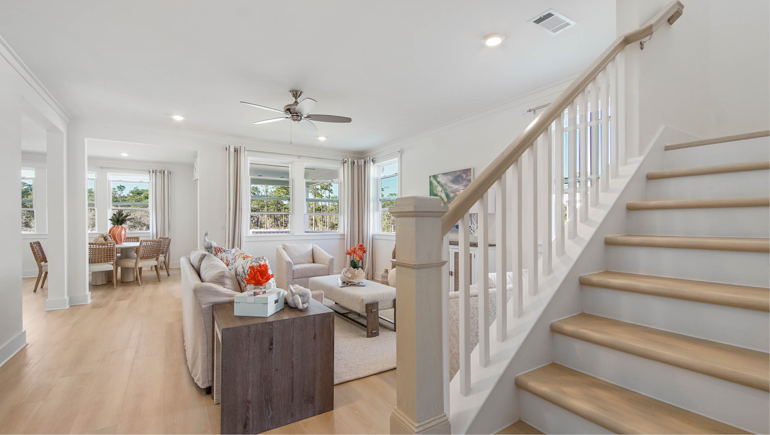 Stairs leading to second level and open to living room
