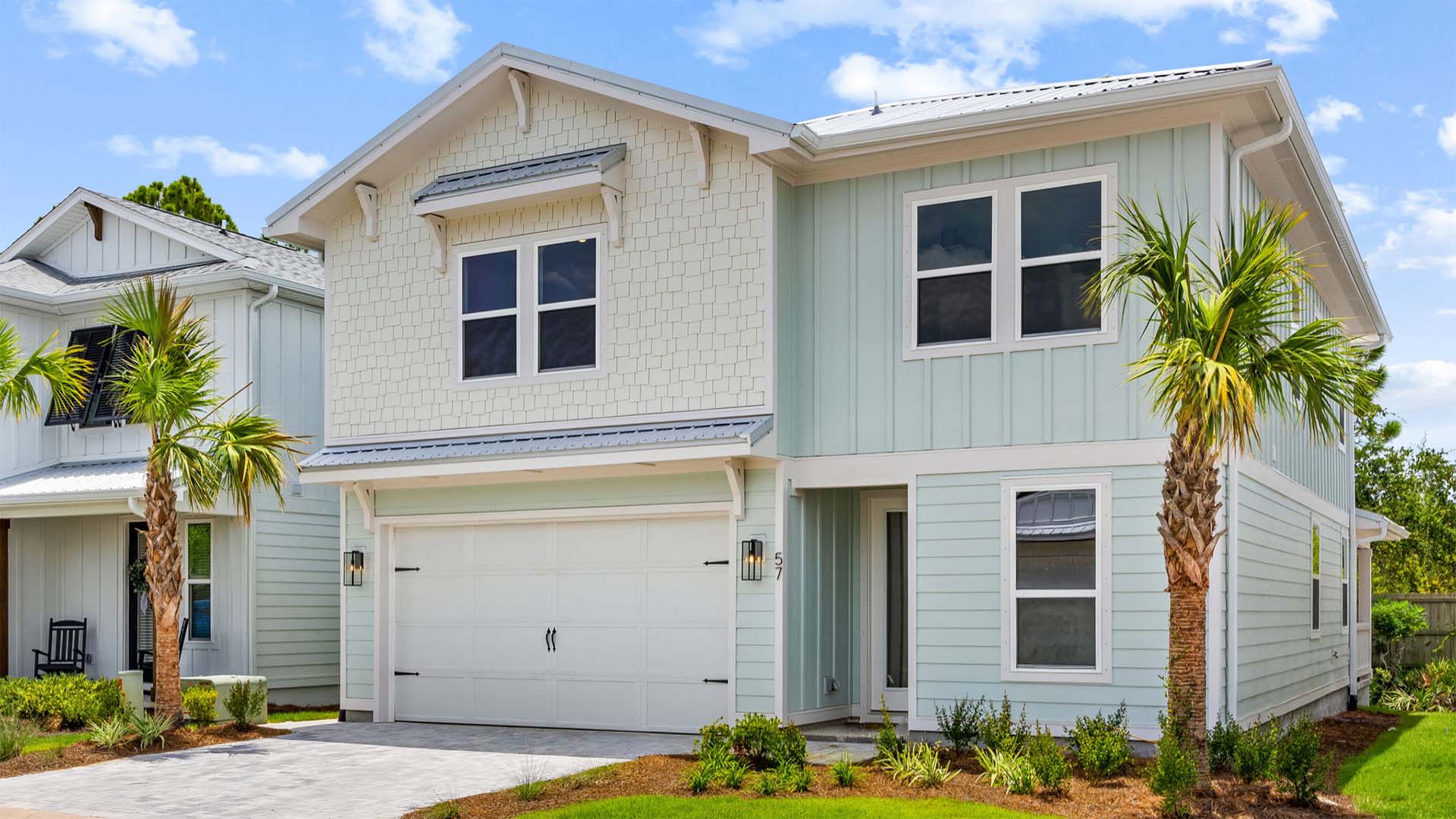 Covered entry, landscaped front door and paver driveway