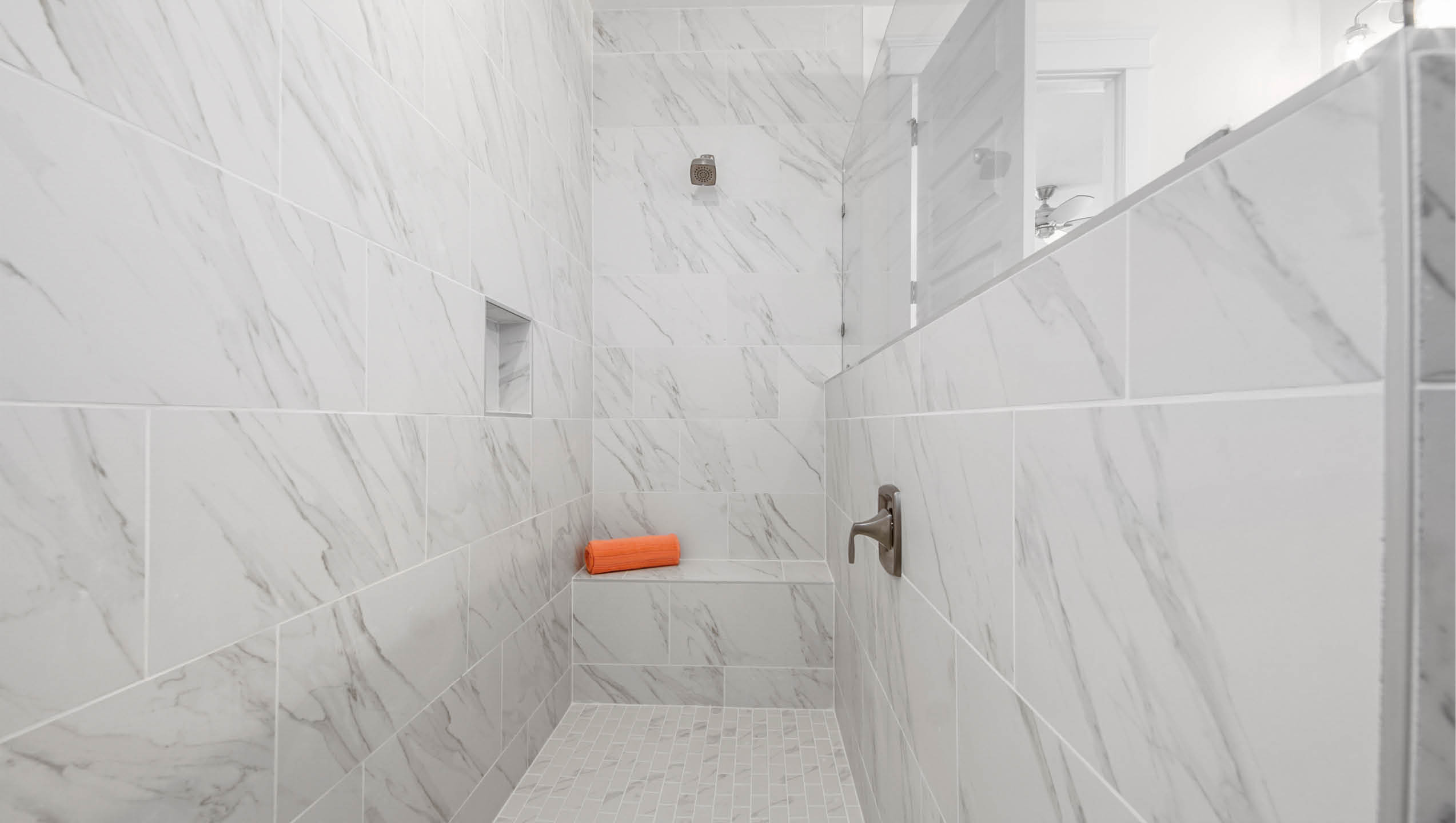 Primary bathroom over size shower with bench