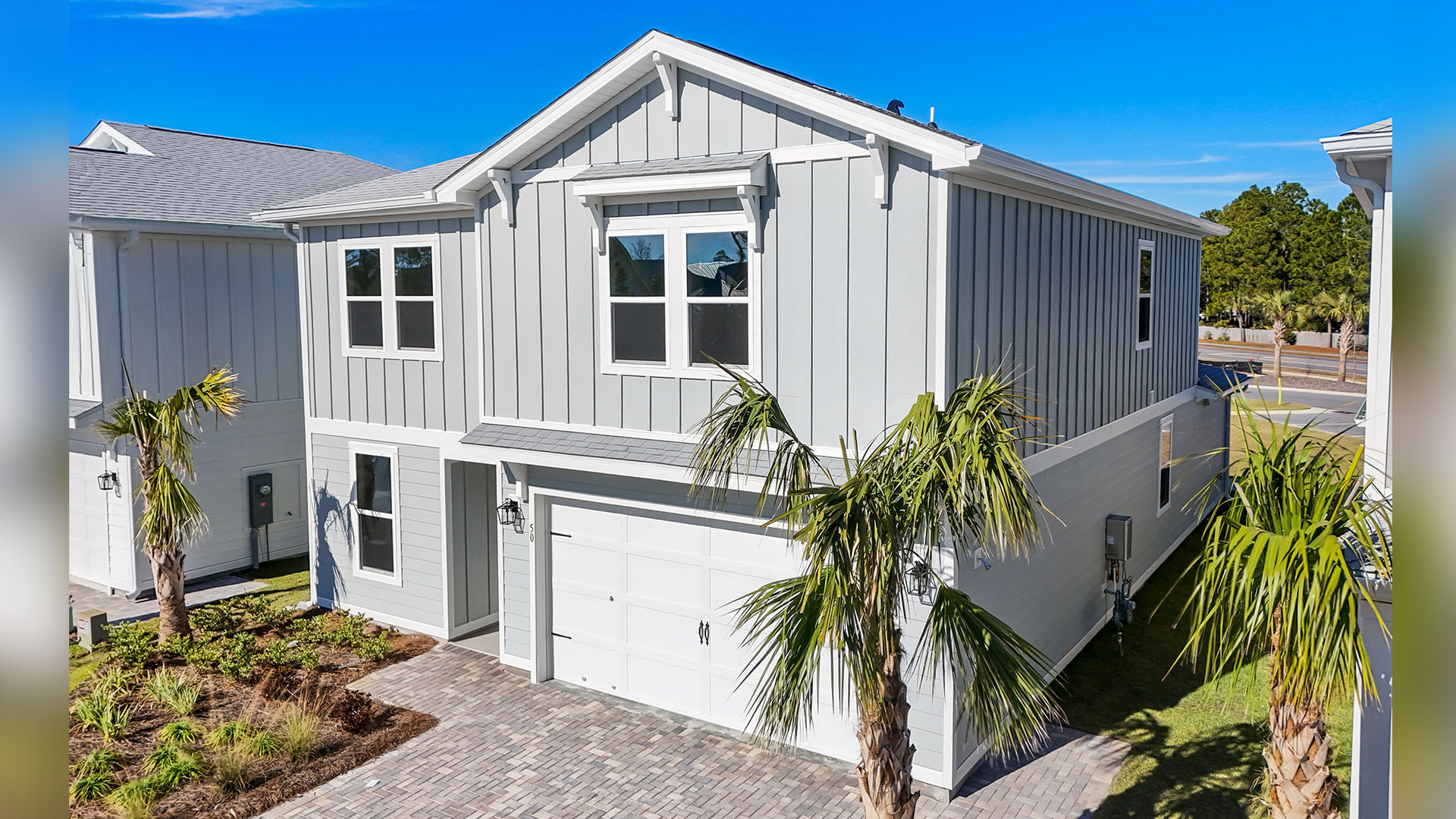 The Ashton features a two car garage and brick paver drive