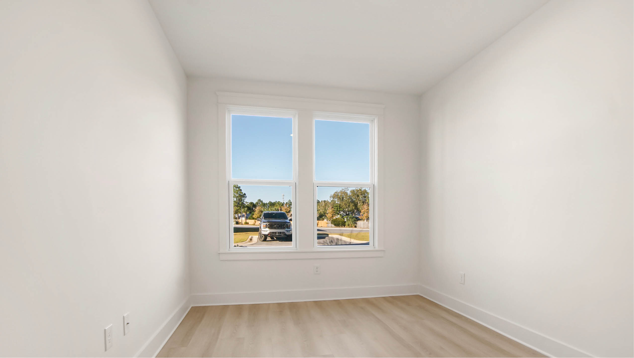 Main level bedroom two with wood floors