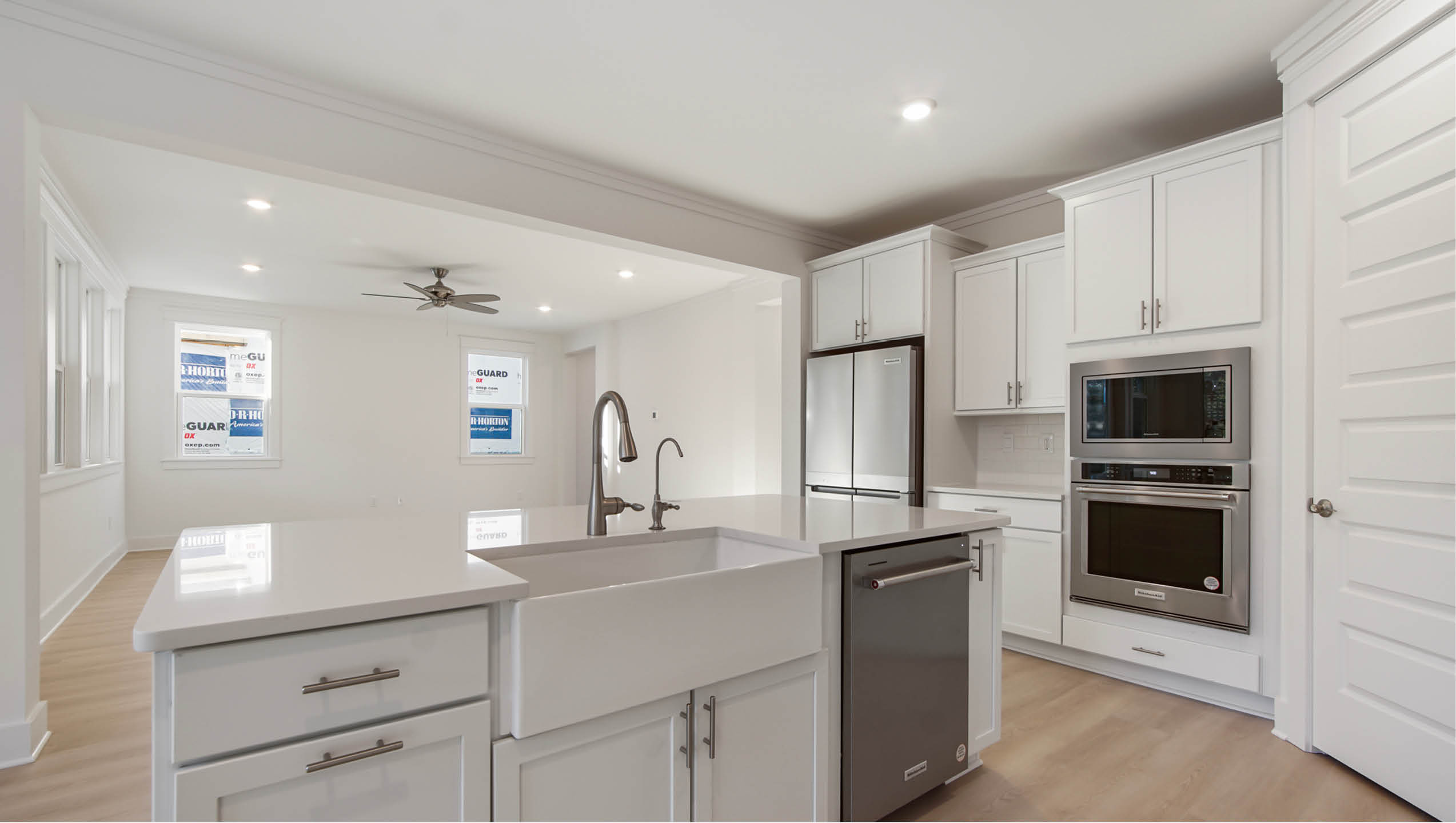 Open kitchen to great room with farm sink and dishwasher in center island