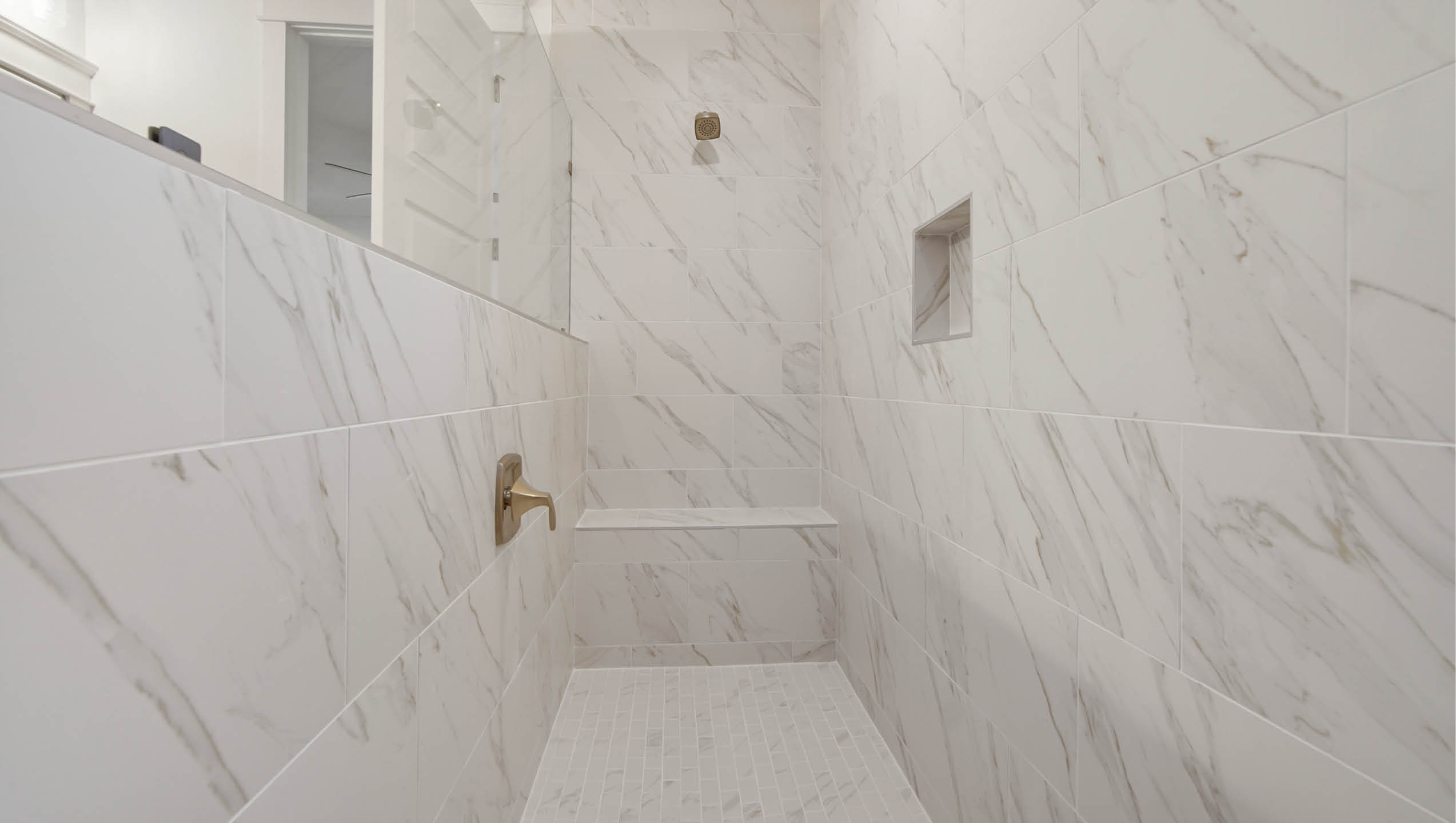 Primary bathroom with open shower and bench