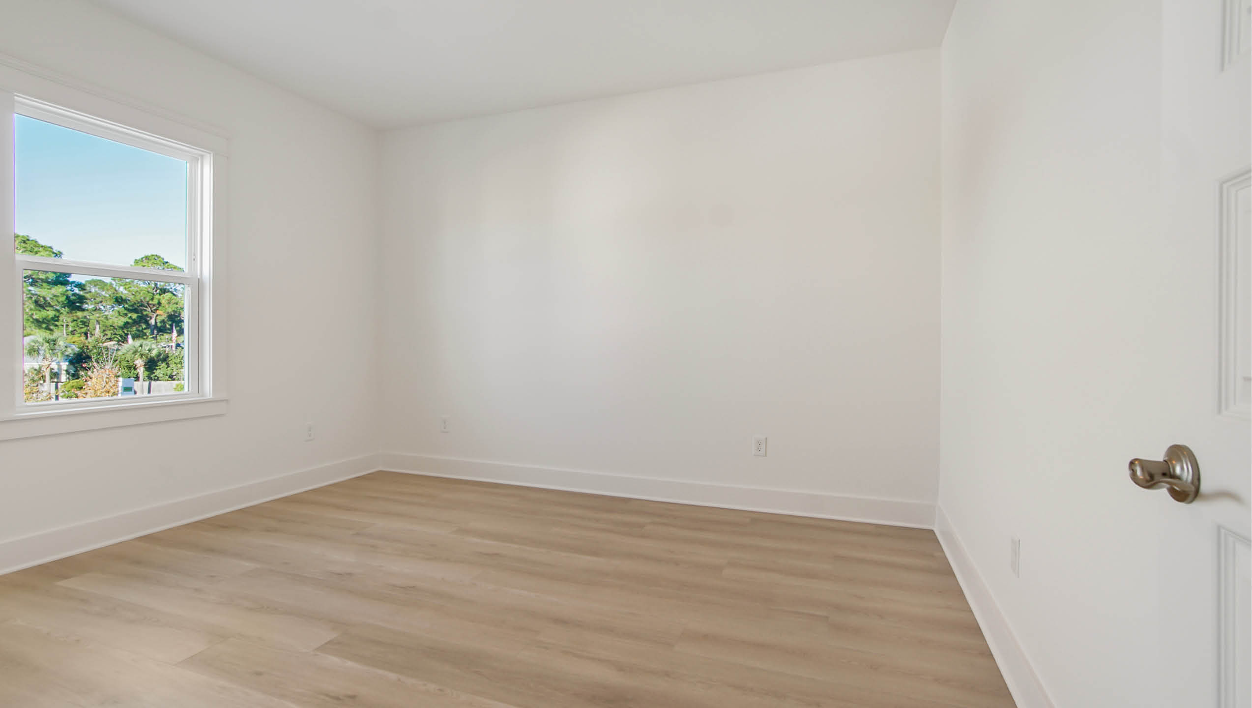 Bedroom three with wood floors