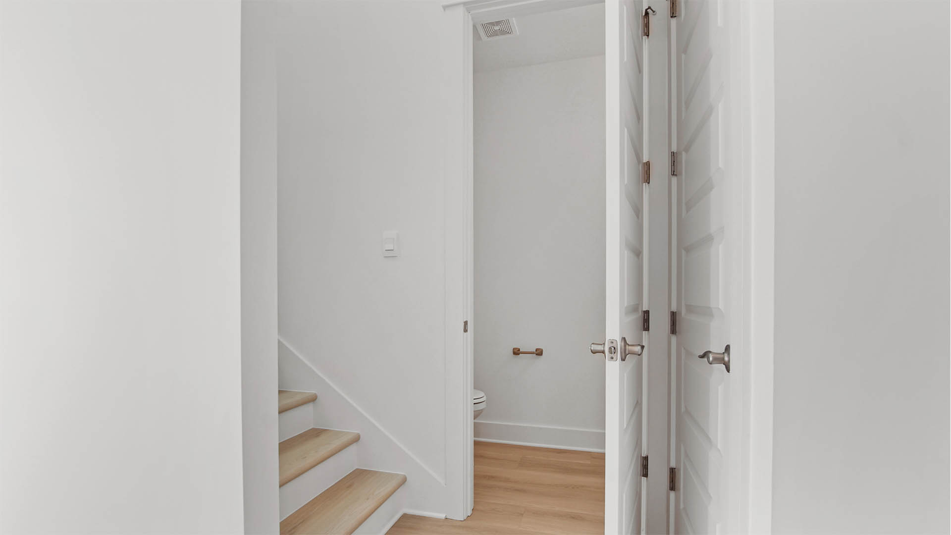 Stairs and powder bath off foyer
