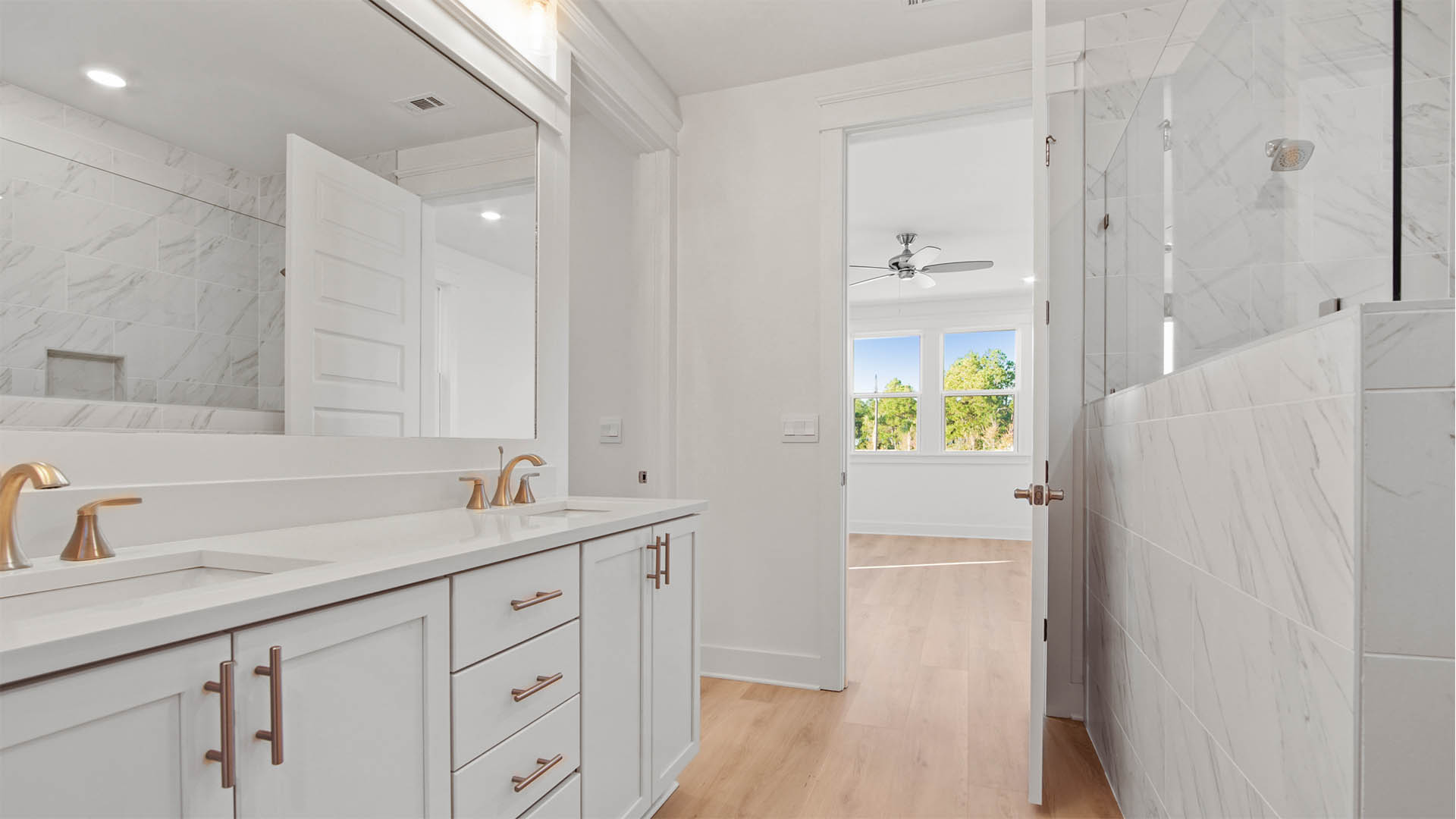 Luxurious primary bathroom with large open shower with glass partition