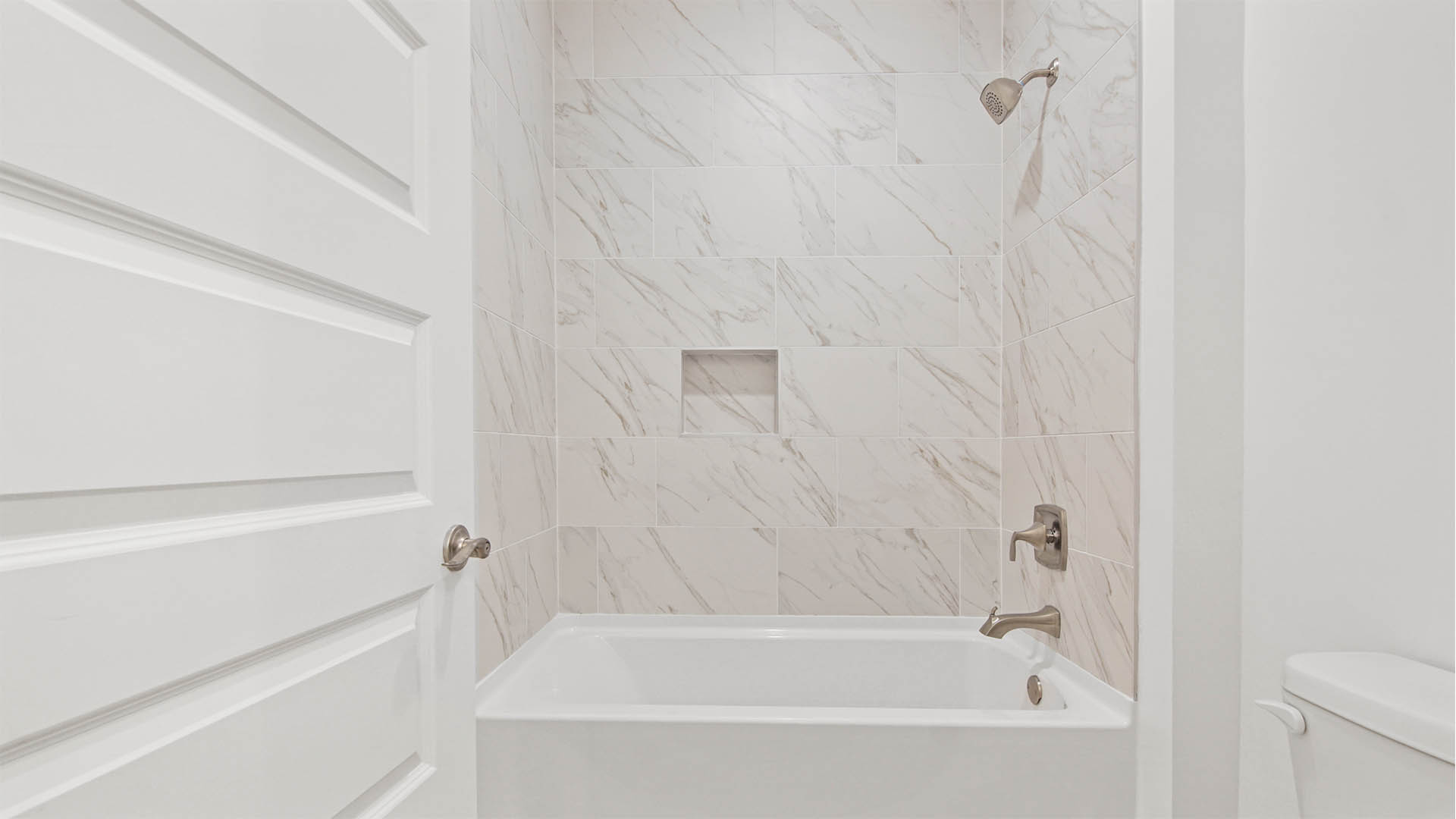 Shared bathroom with dual sink vanity with quartz countertop and elegant fixtures