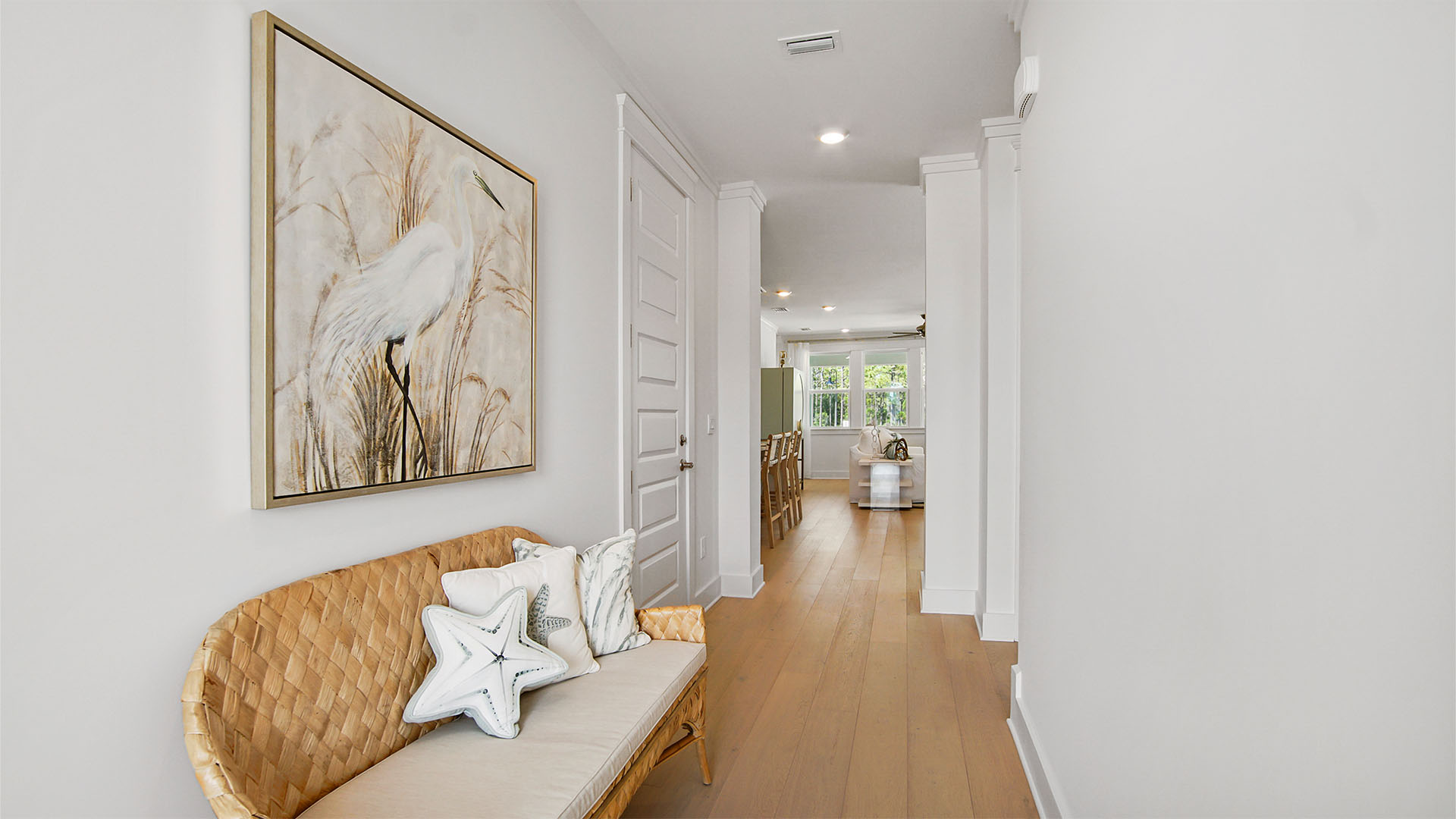 Foyer with wood flooring and garage entrance.