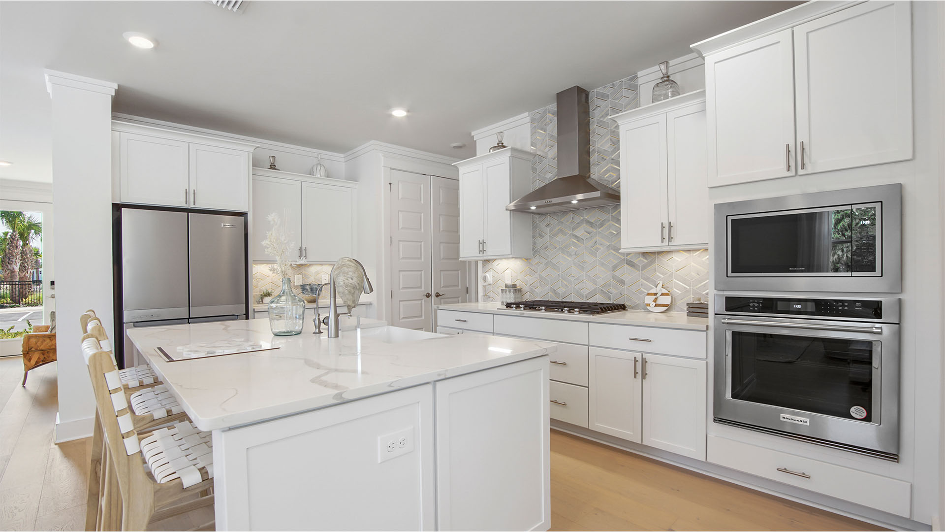 Open kitchen with stainless-steel appliances and large kitchen island and pantry.