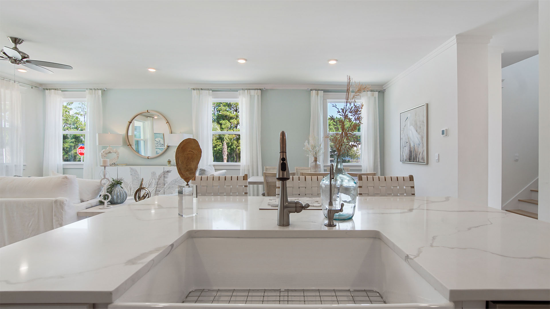 Kitchen island with quarts countertops and well sink and bar seating.