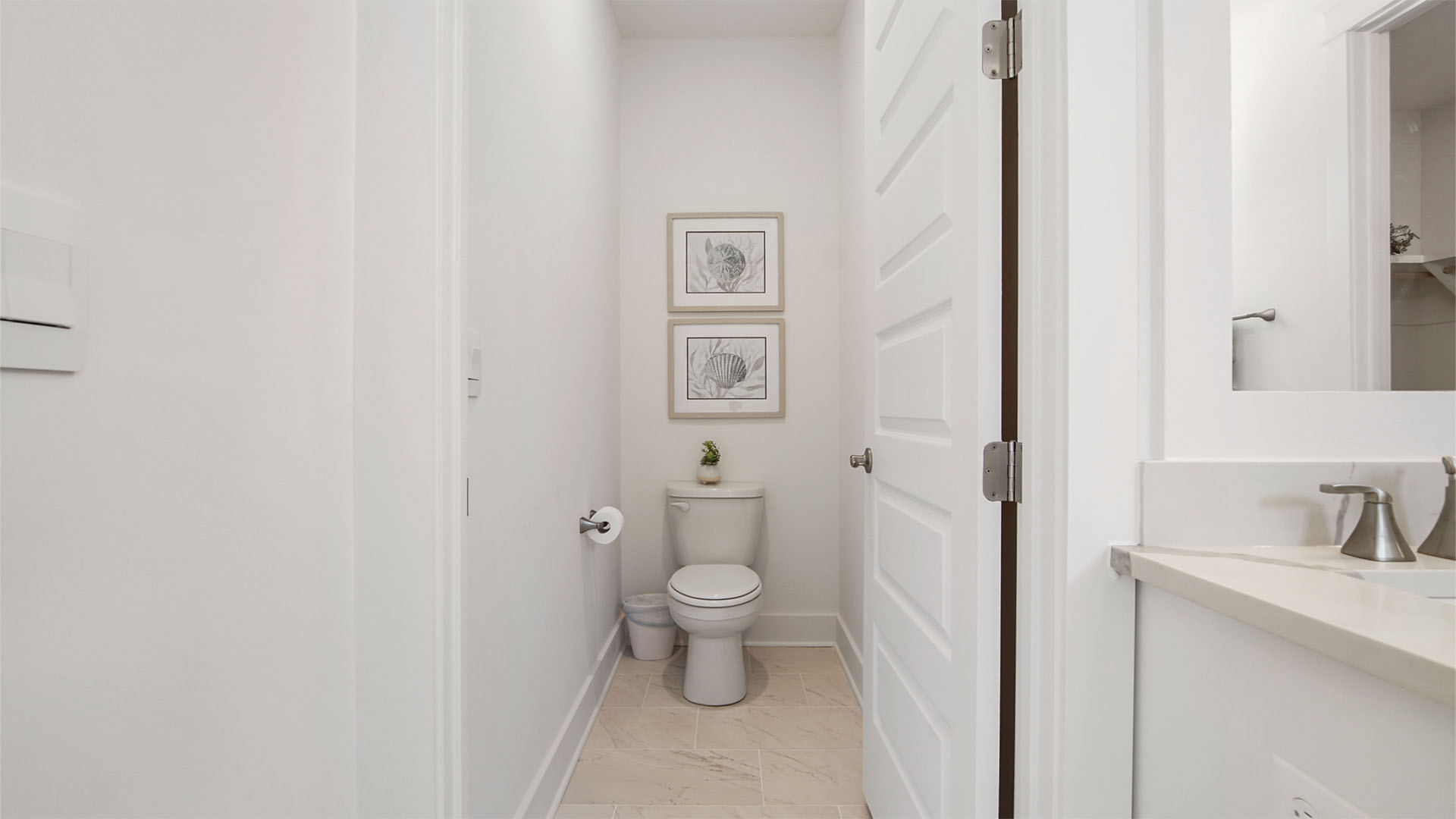 Primary bathroom water closet and tile flooring.