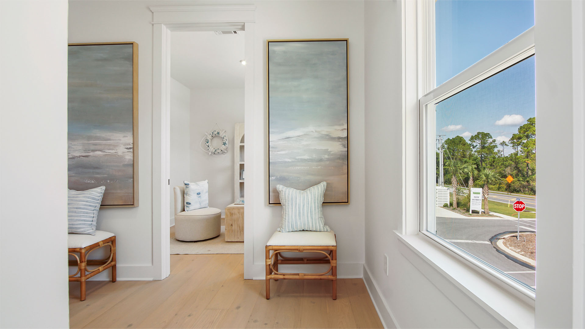 Upstairs landing with window and wood flooring and flex room entrance.