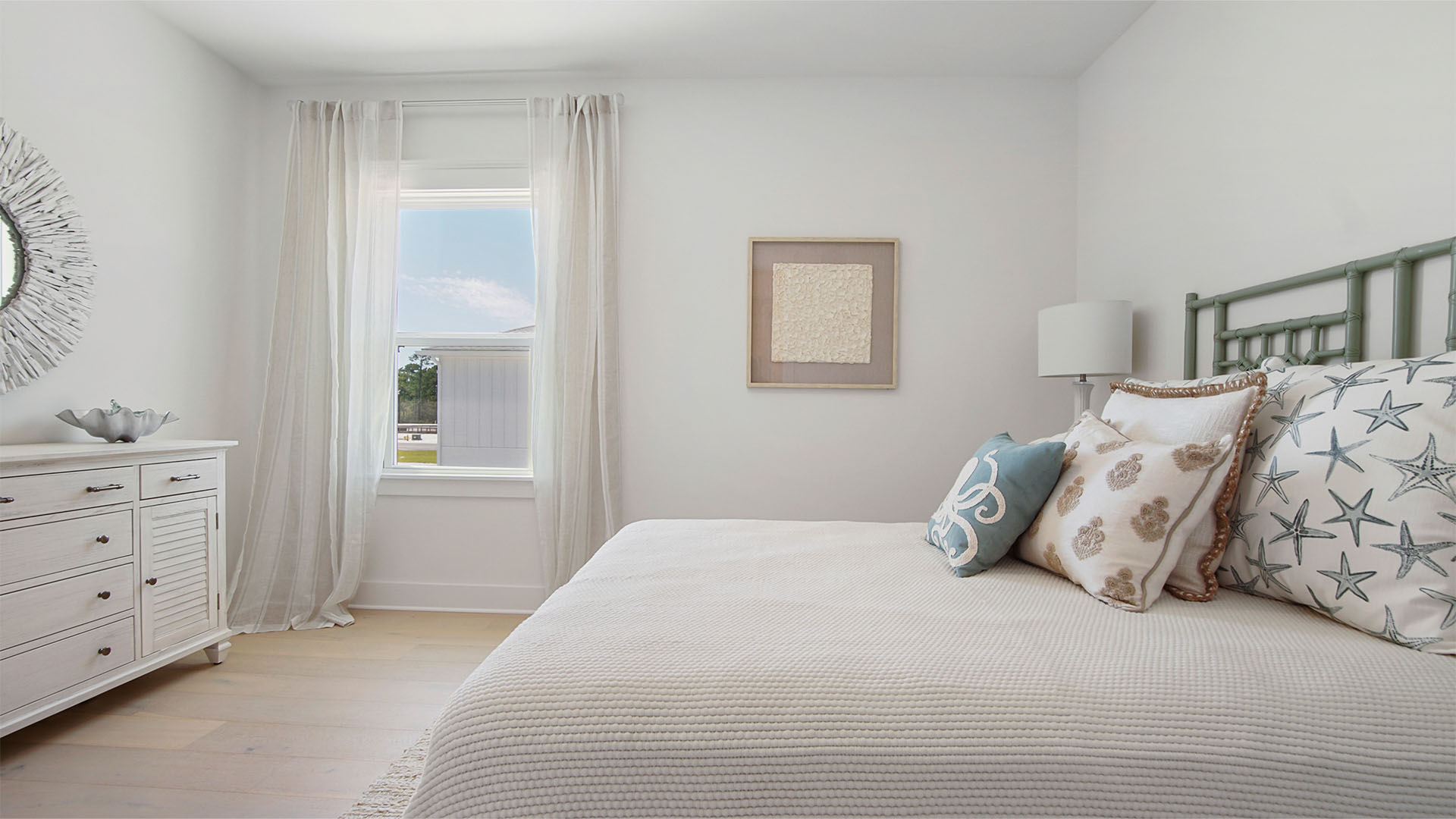 Bedroom two with wood flooring and window.