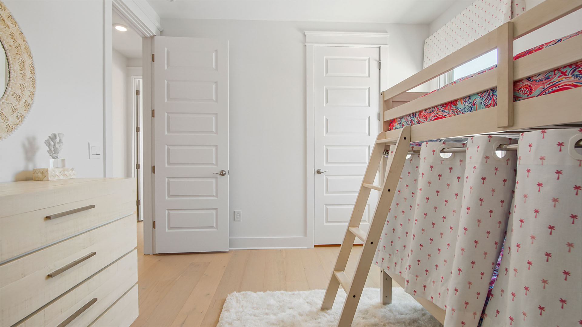 Bedroom three with wood flooring and door to walk-in closet.