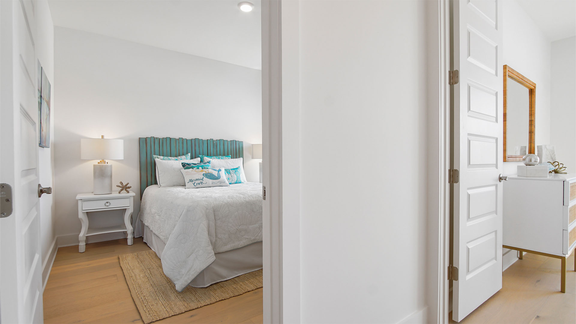 Bedroom four entrance from hallway with wood flooring.