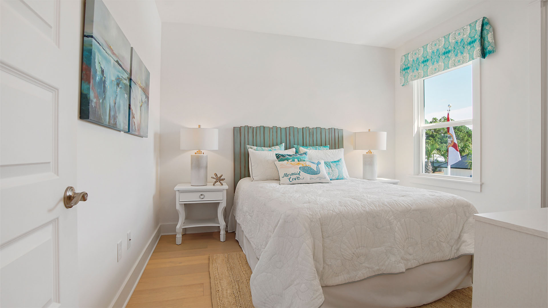 Bedroom four with window and wood flooring.