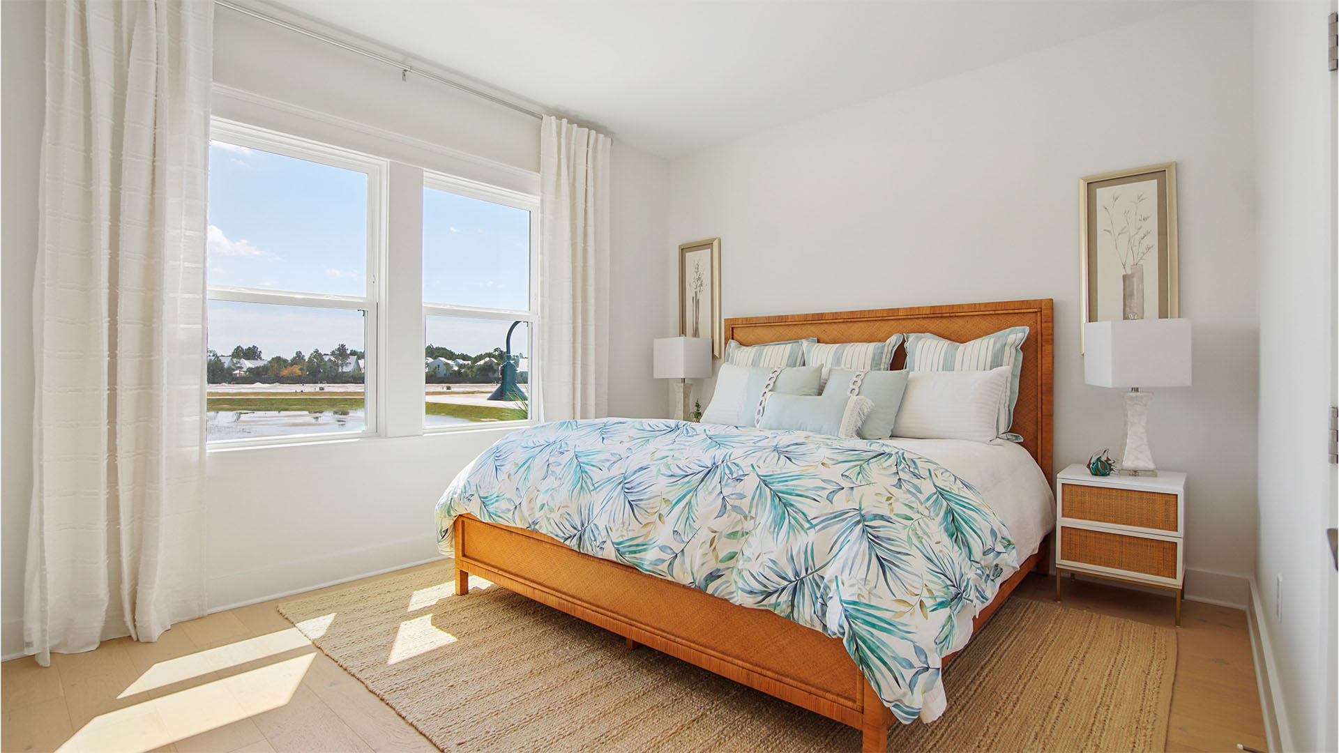 Bedroom five with wood flooring and two windows.