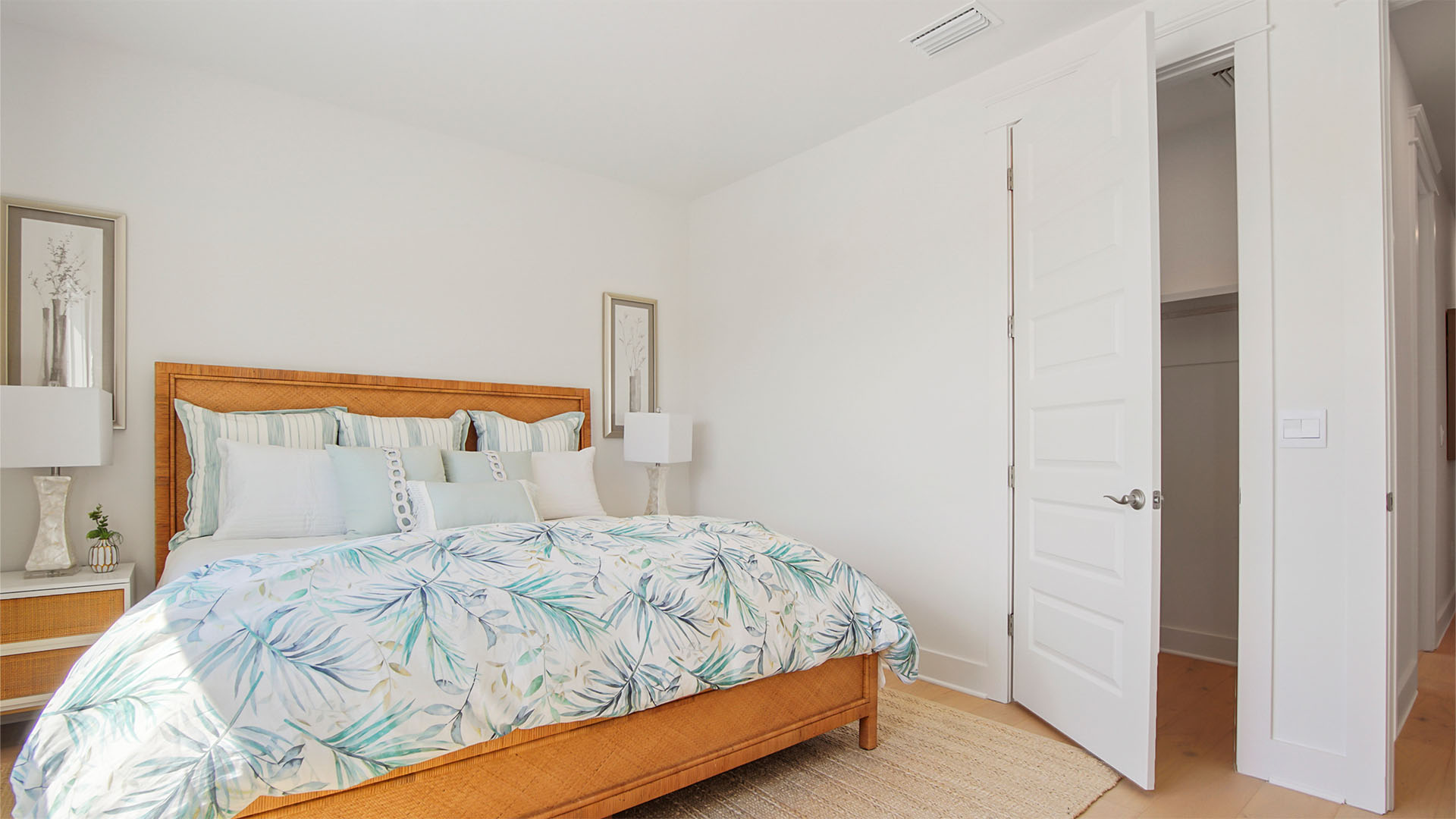 Bedroom five with wood flooring and wall-in closet.
