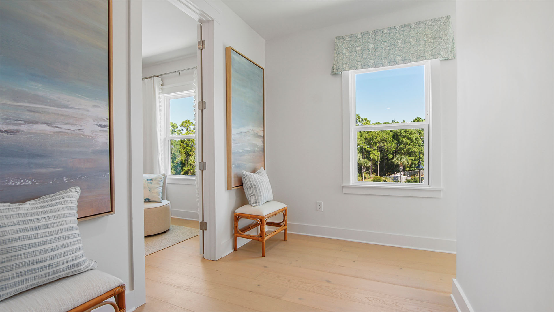 Upstairs landing next to flex room with window and wood flooring.