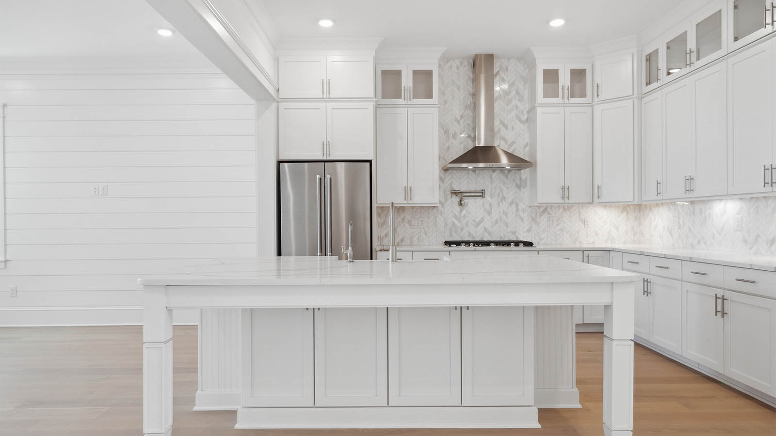 The kitchen has a center island with lower cabinetry for storage