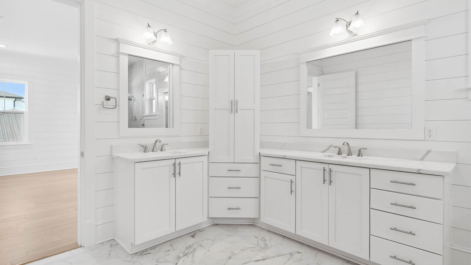 The primary bathroom on the third level has lower cabinetry for storage