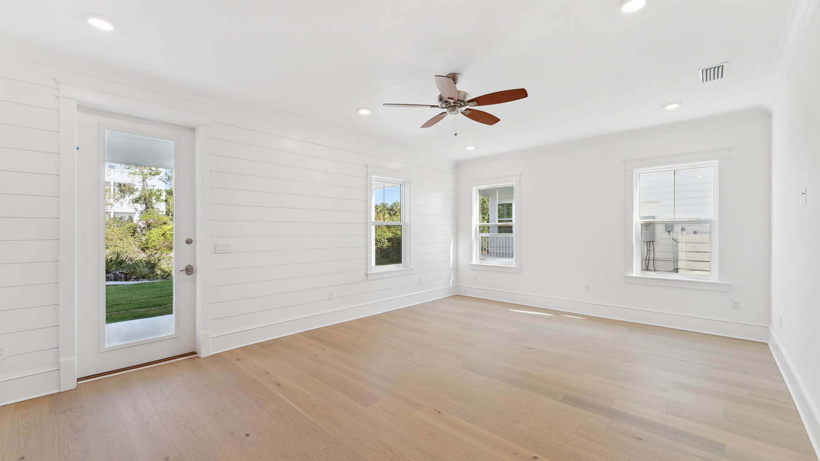 The flex space is open and spacious and encompassed by natural light from the many windows