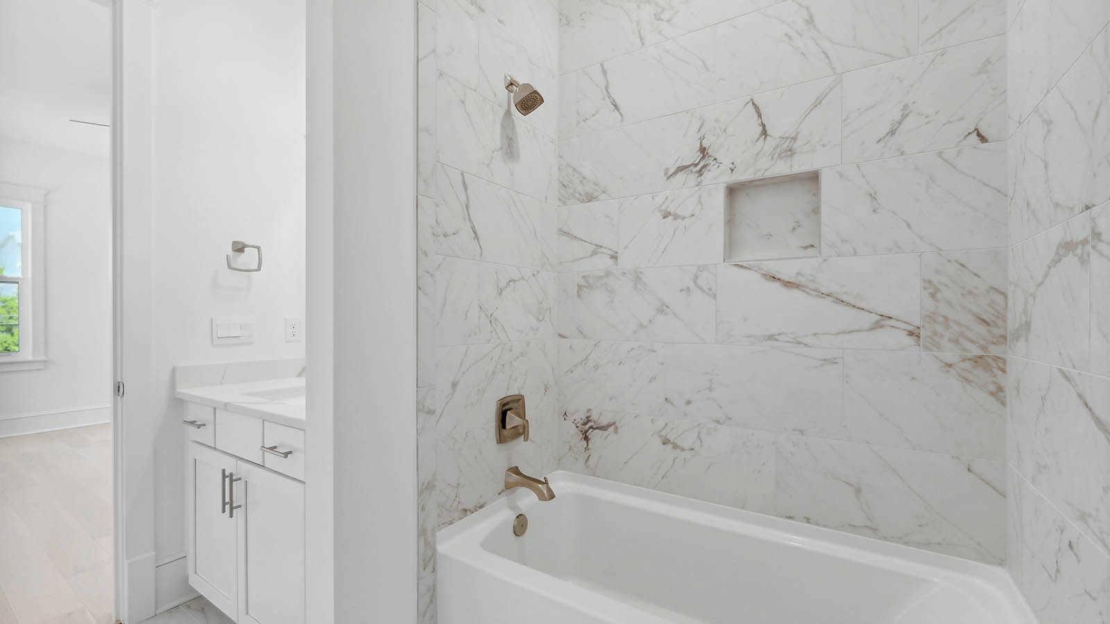 The full bathroom has a tub and shower