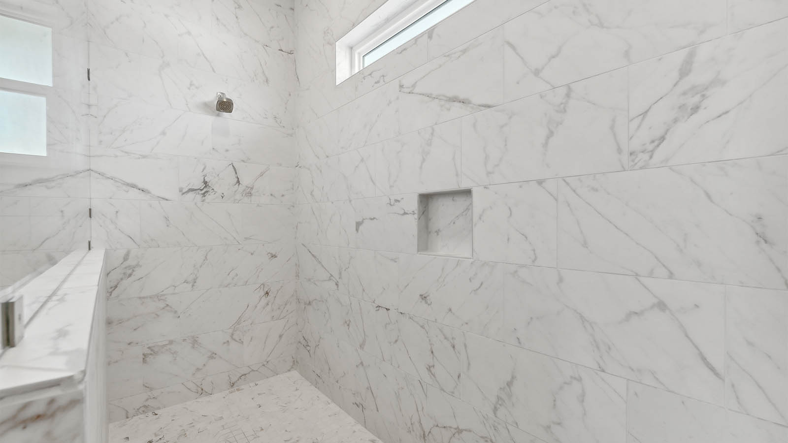 The separate shower is large and has a glass window